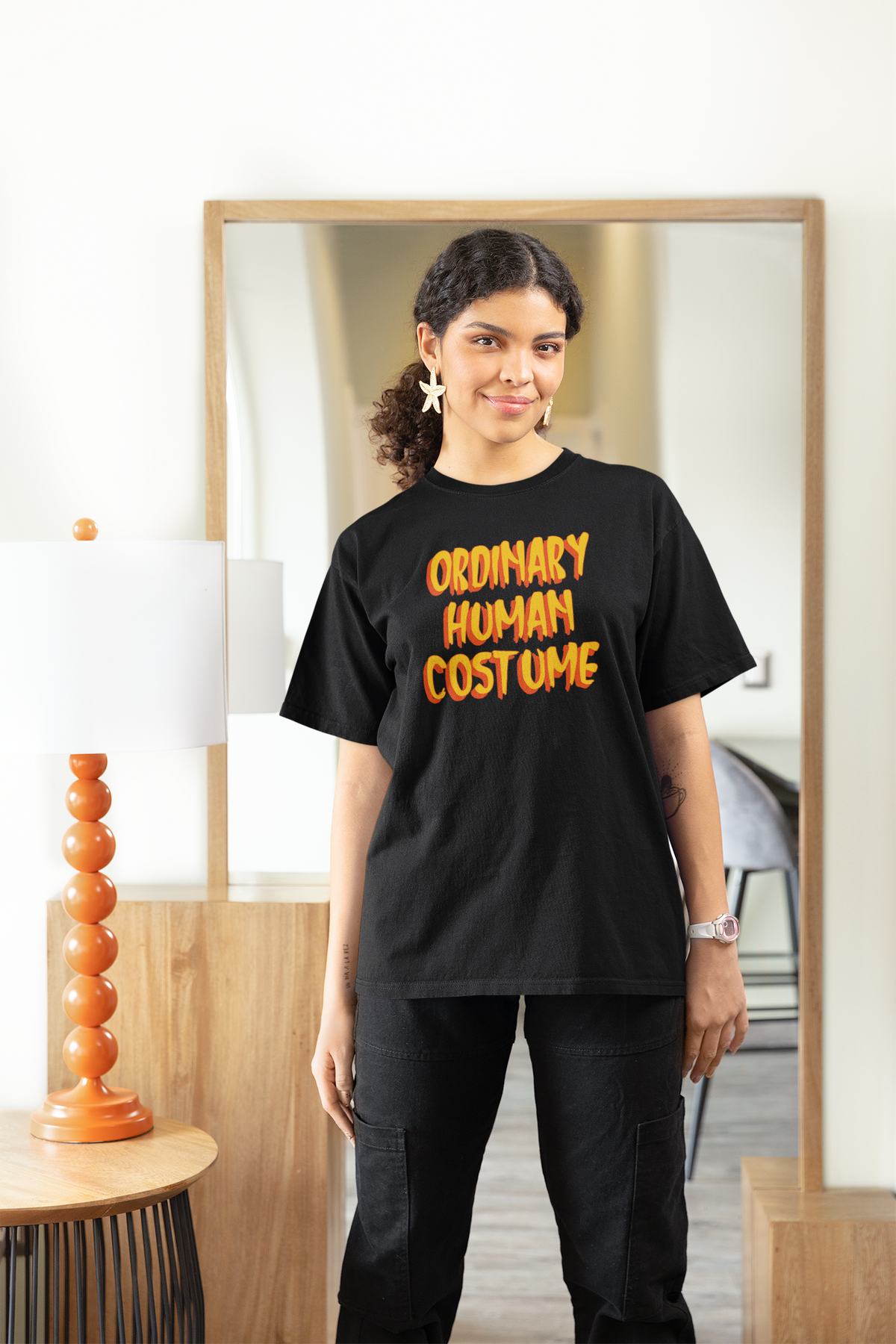 'Ordinary Human Costume' funny halloween t-shirt in black, woman wearing it indoors, funny costume gift
