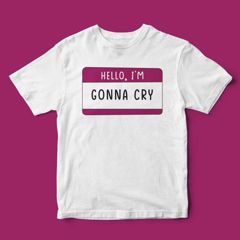 The Hello, Gonna Cry T-Shirt blends casual style with humor. This white tee on a magenta background features a witty name tag design that says, "HELLO, I'M GONNA CRY.