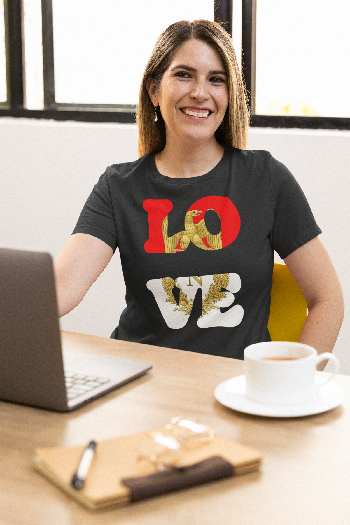 'LOVE Listenbourg' t-shirt in black, smiling woman wearing it at a desk