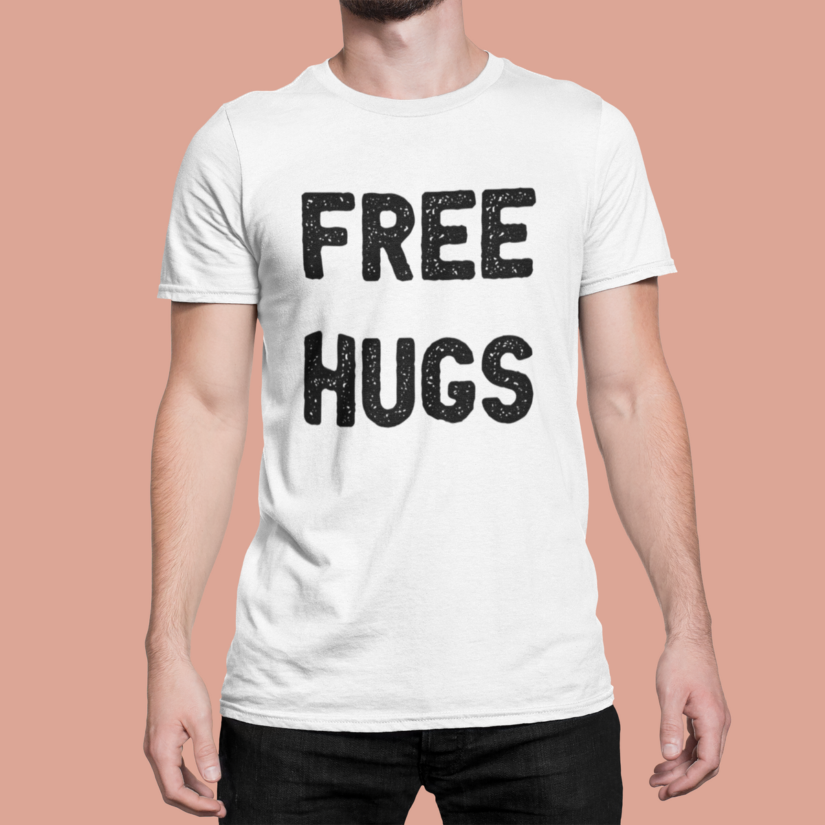 'Free Hugs' t-shirt in white, man wearing it on pink backdrop, funny sarcastic shirt gift idea