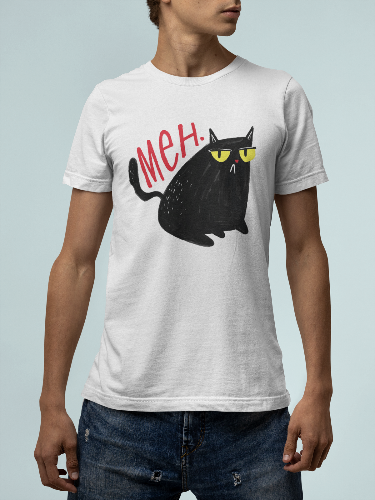 'Meh' black cat T-shirt in white, man wearing it against a light backdrop, funny cat lover shirt