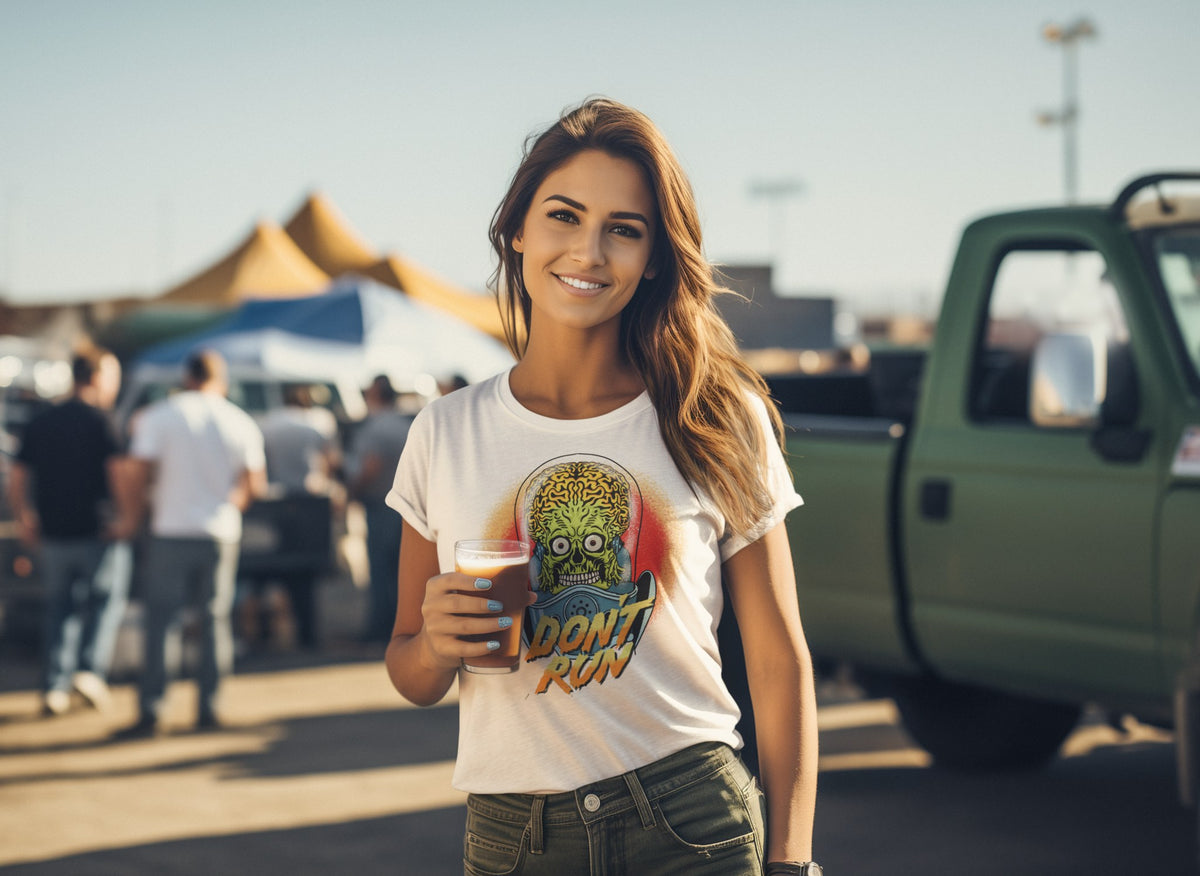 Don't Run alien graphic women's tee in black, woman wearing it on an urban backdrop, horror and sci-fi fan top