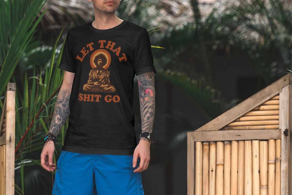 Let That Shit Go tee in black, man standing by a bamboo fence outdoors, funny zen gift