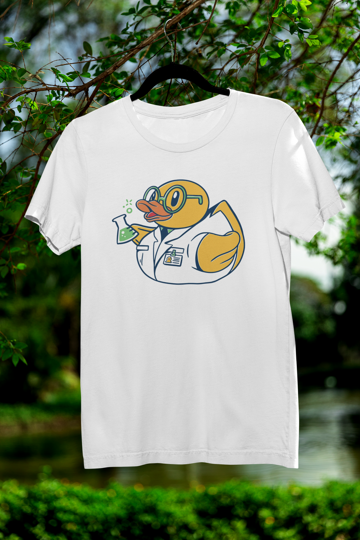 Science duck t-shirt in white, hanging outdoors among green trees, funny chemistry gift for duck lovers