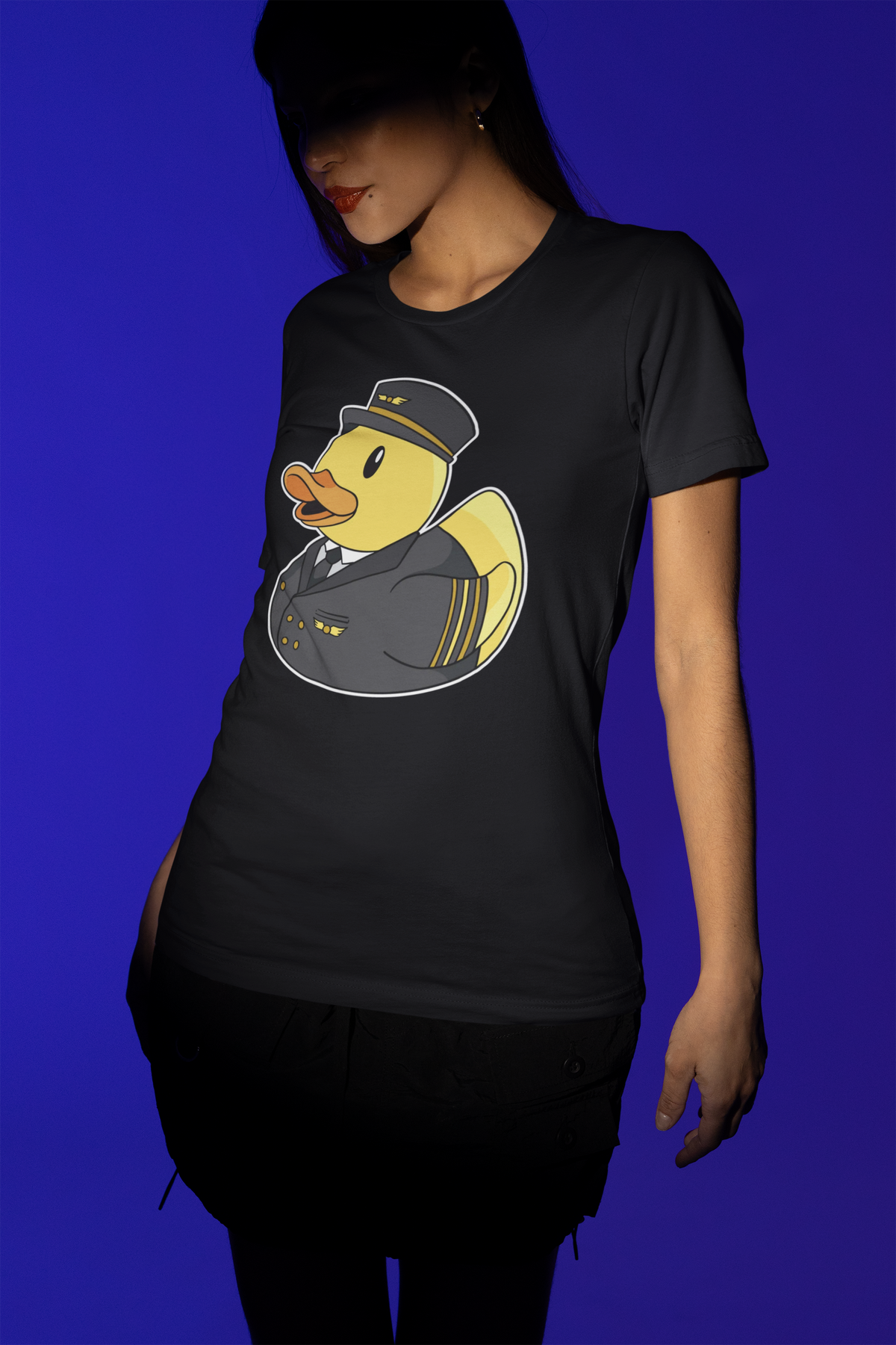 Pilot duck t-shirt in black, woman model wearing it against a blue background, funny pilot gift shirt