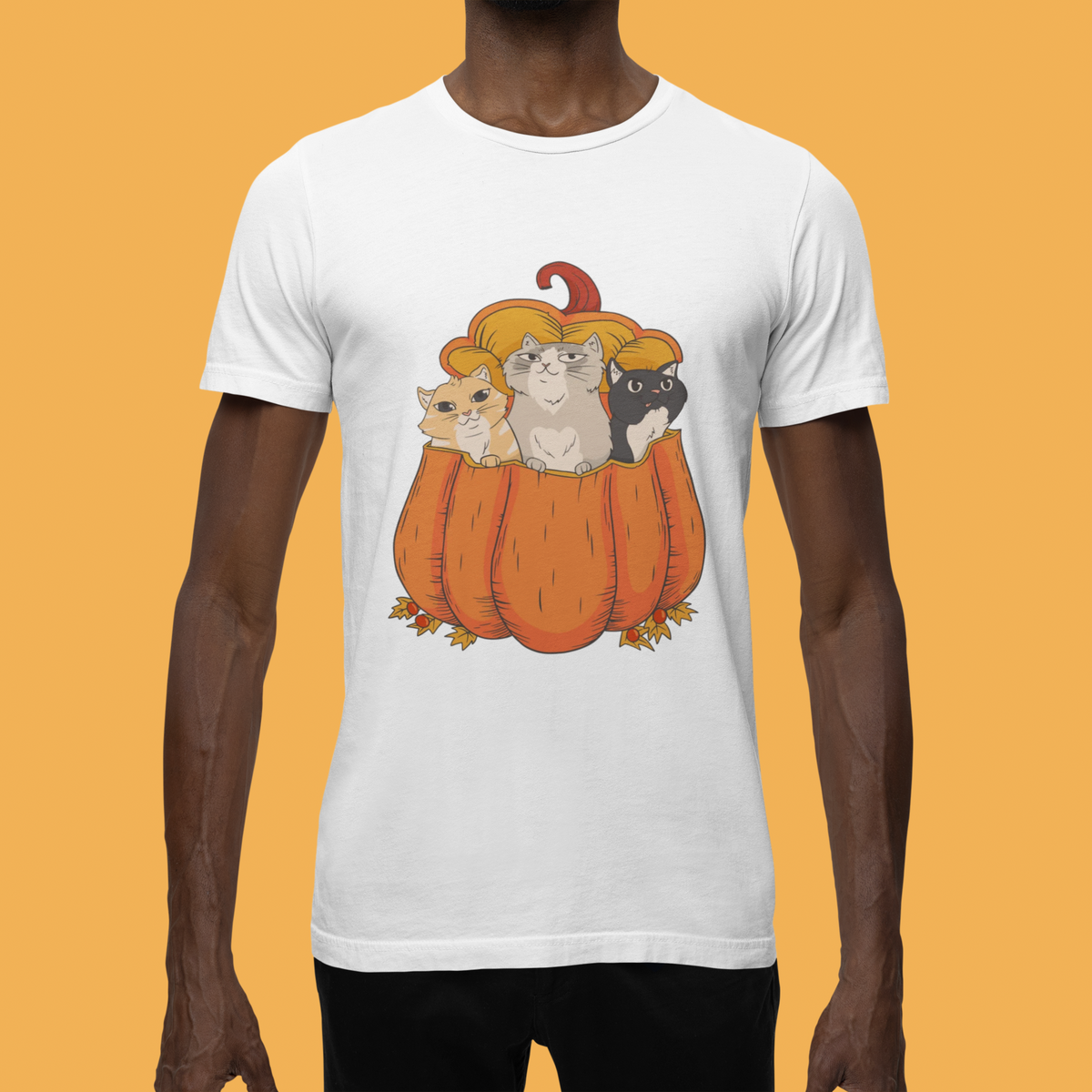 Halloween Cats in a pumpkin T-shirt in white, man wearing it against a yellow backdrop, cat lover gift