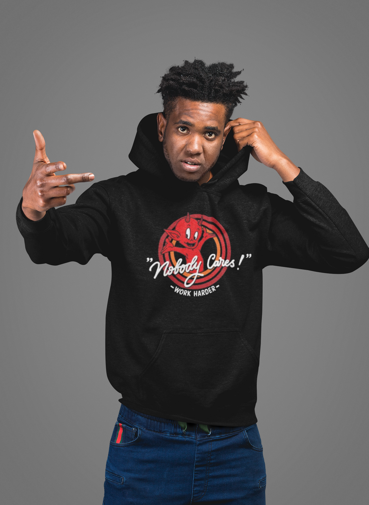 'Nobody Cares' hoodie in black, man wearing it in a studio, Hoodie mockup, Geekpsters