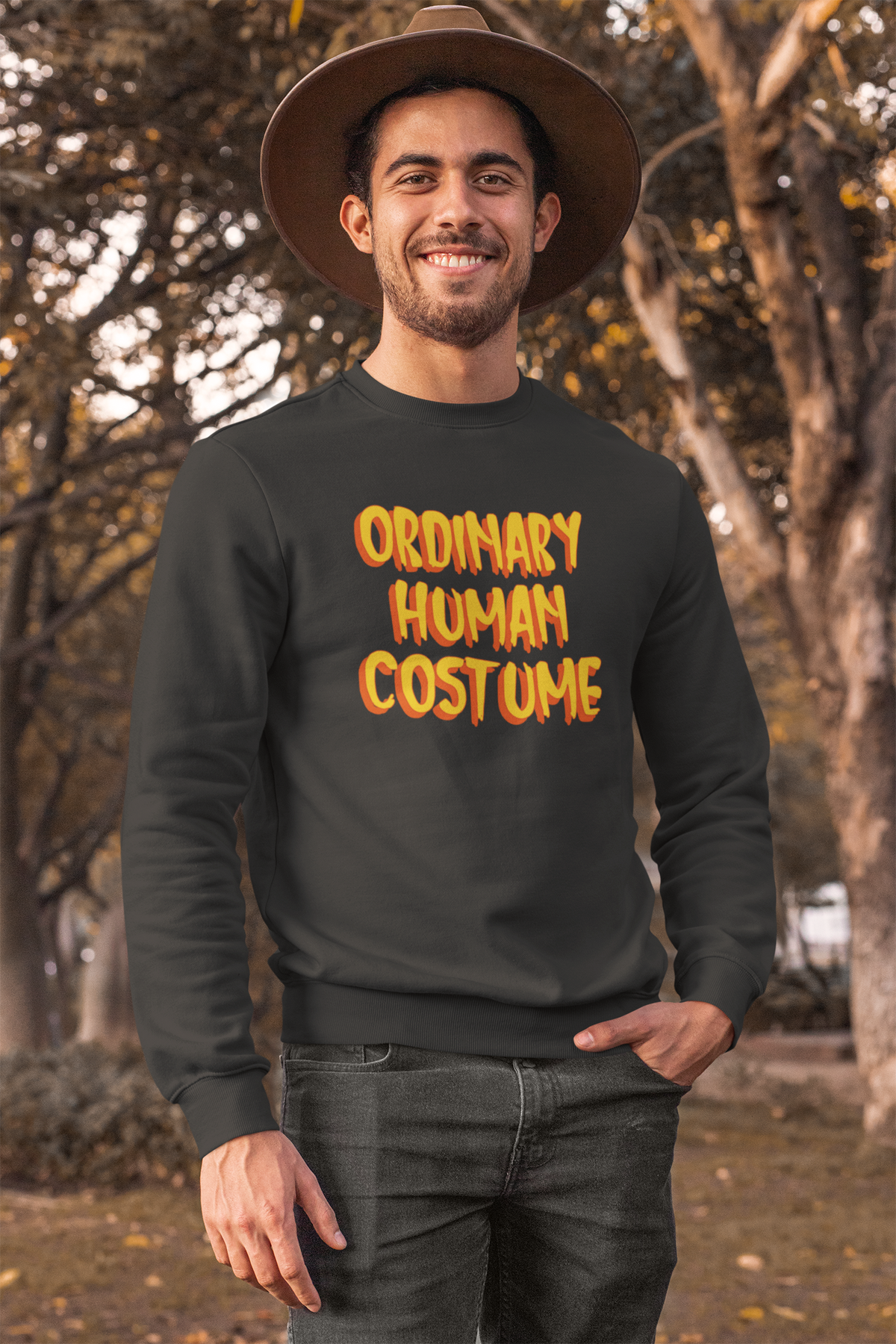 'Ordinary Human Costume' funny halloween sweatshirt in black, man wearing it outdoors, funny costume gift