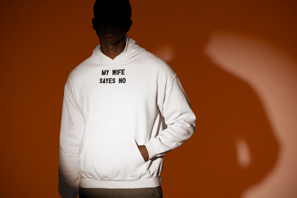 'My Wife Says No Hoodie' in white, man under a spotlight, Hoodie mockup, Geekpsters