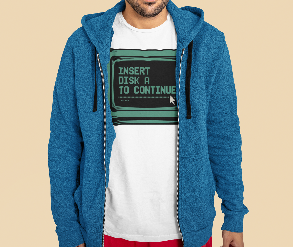 'Insert Disk A To Continue' oversized tee in black, man wearing it under a blue zip hoodie, funny developer gift