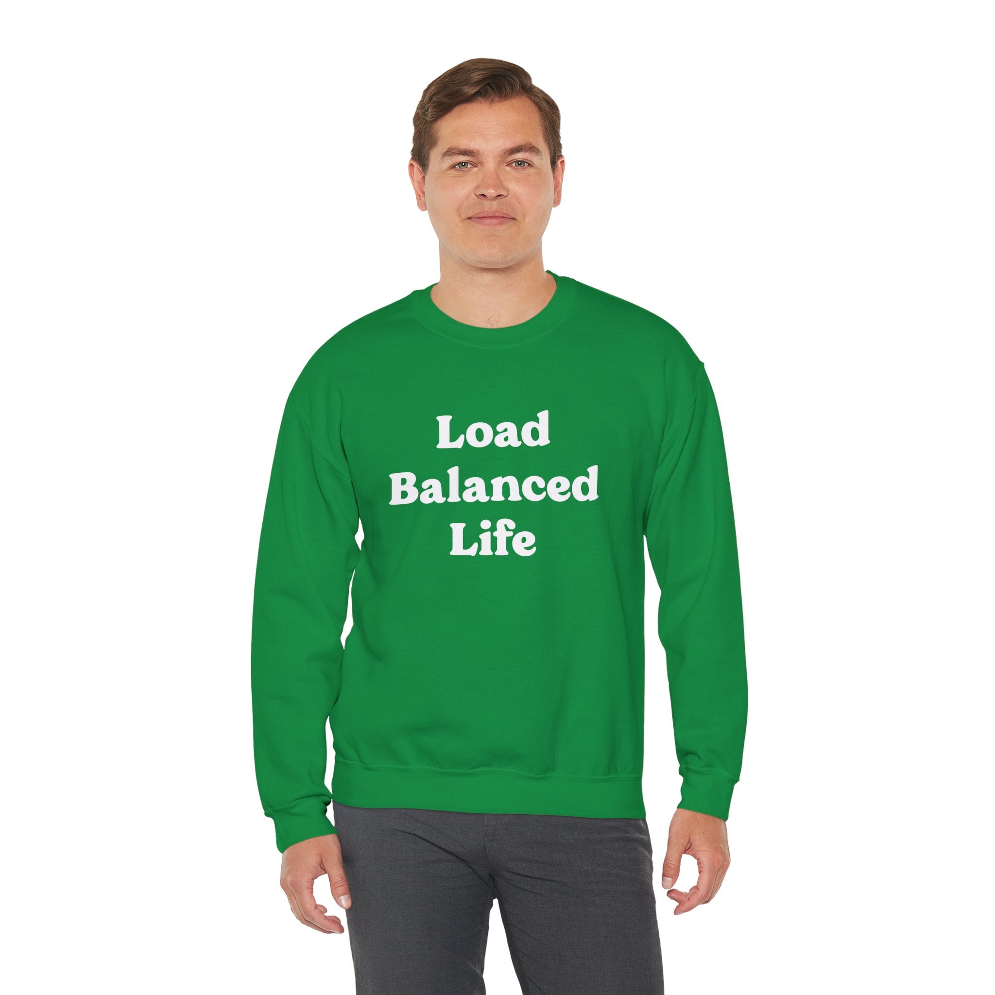 Dressed in a Load Balanced Life - Sweatshirt, an individual enjoys cozy comfort, their sweatshirt proudly displaying the phrase "Load Balanced Life" in green.