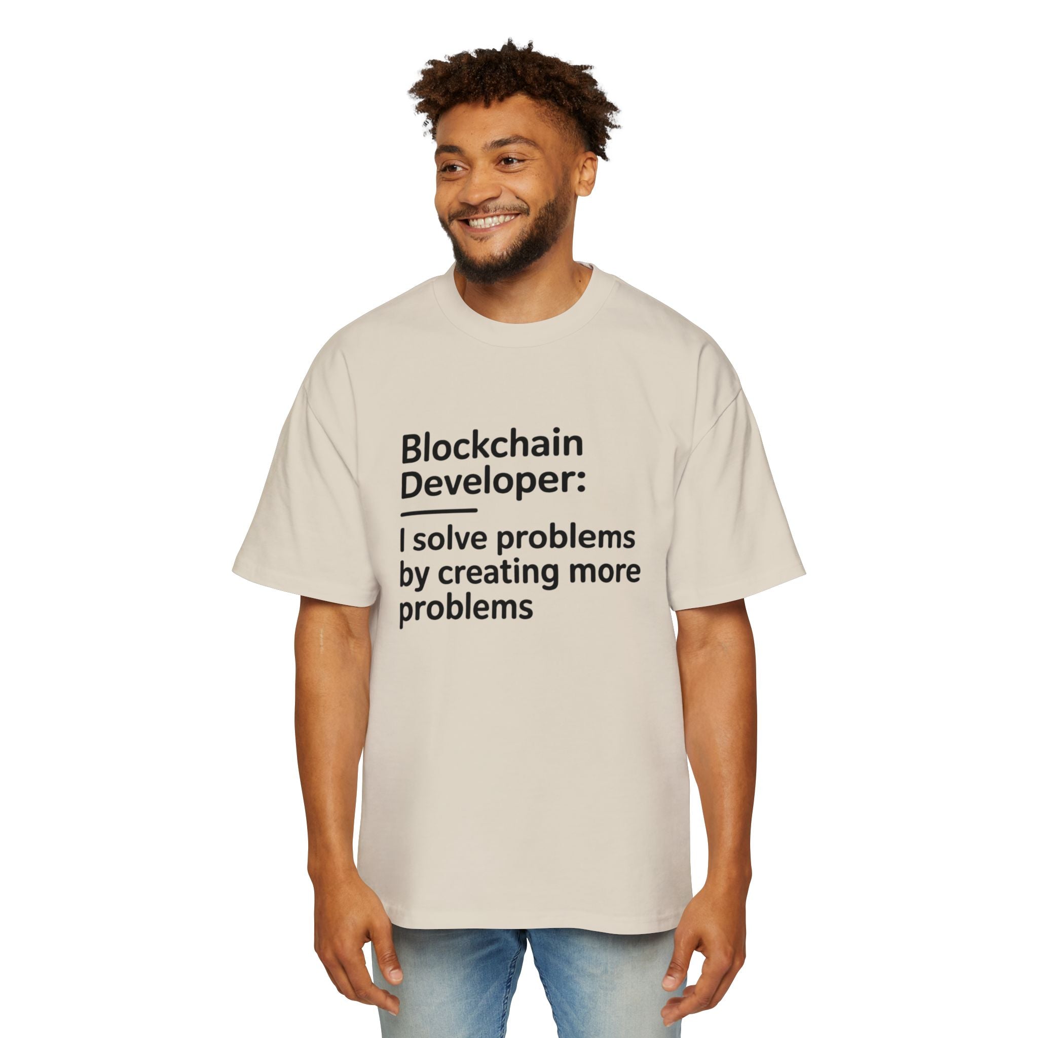 A man wears the Blockchain Developer - Heavy Oversized Tee, an oversized beige t-shirt made from 100% cotton, featuring the text: "Blockchain Developer: I solve problems by creating more problems.