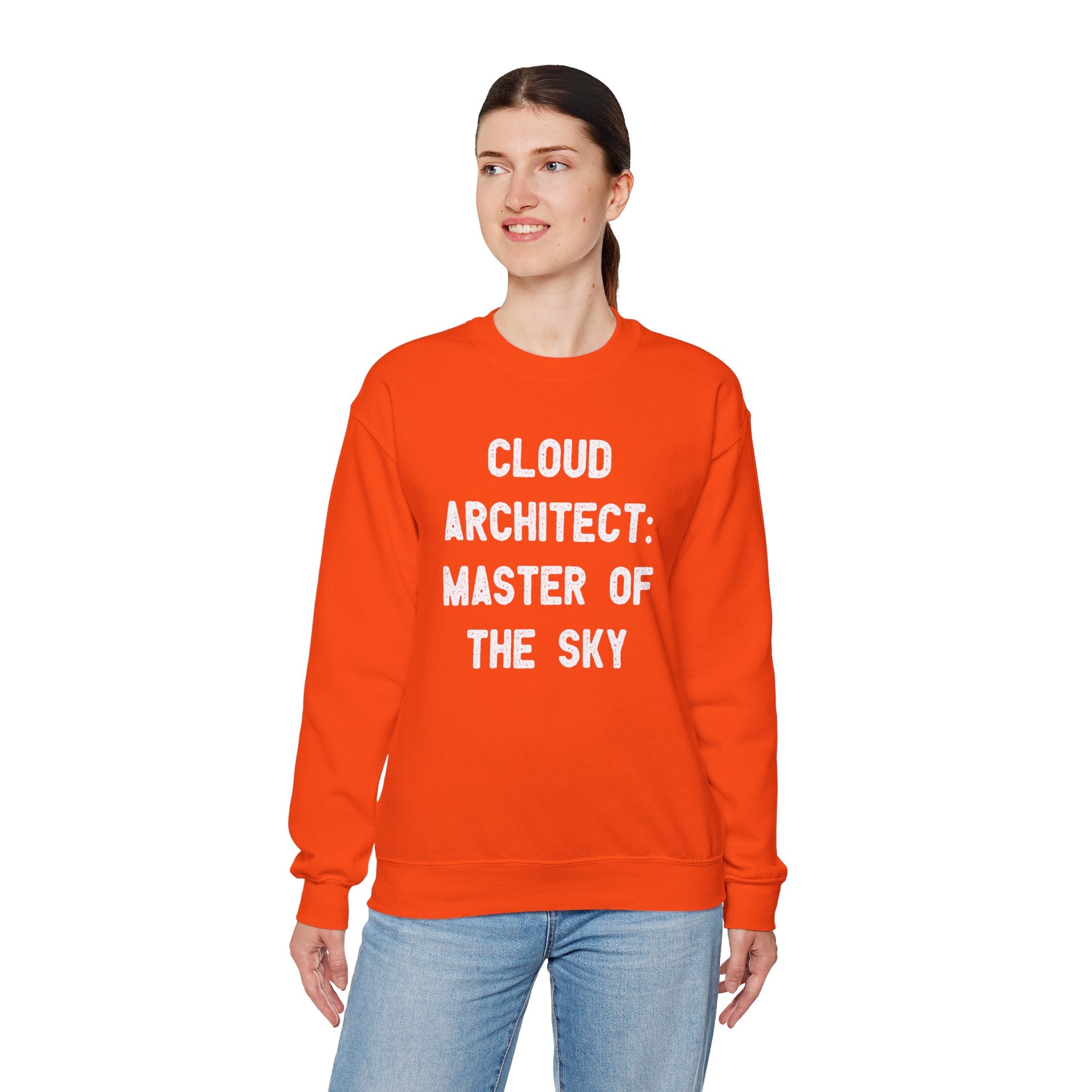 Sporting the Cloud Architect Master of the Sky sweatshirt, a person confidently displays their cloud design expertise with its vibrant orange hue and bold text against a plain backdrop.