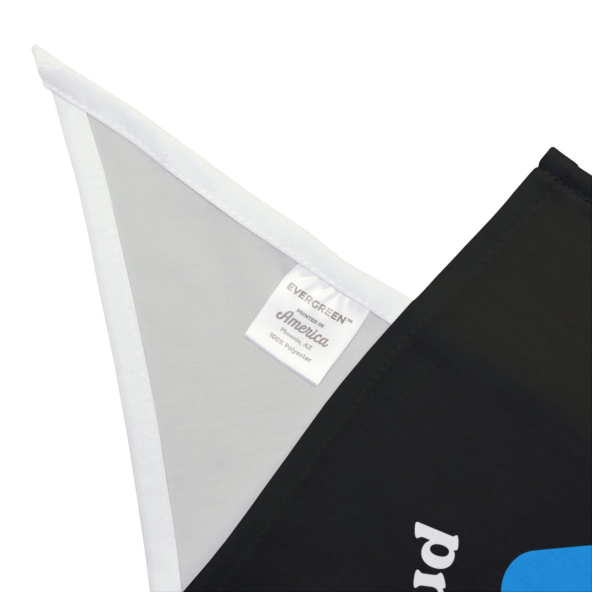 Close-up of a black and white fabric piece crafted from soft-spun polyester, featuring a white label that reads "Evergreen America 100% polyester," attached to a triangular white edge. This piece resembles the chic Cache Me in The Cloud - Pet Bandana, perfect for elevating your pet's style.