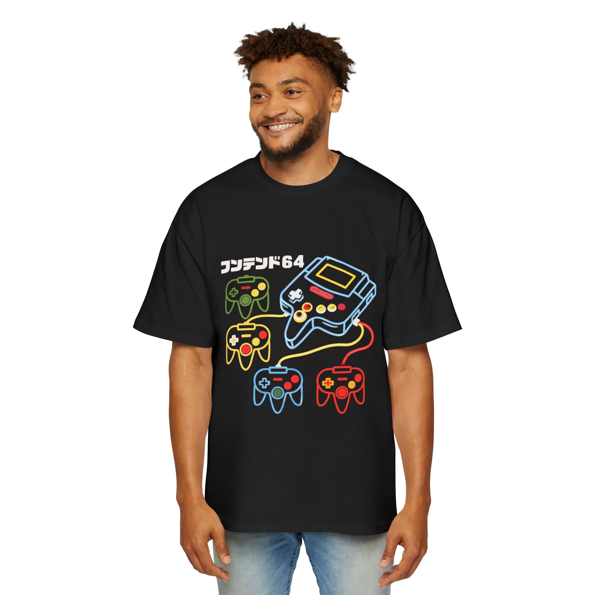 A man wearing the Game Console - Heavy Oversized Tee, an oversized black cotton shirt with a boxy fit, decorated with colorful outlines of four game controllers, a console, Japanese text, and "64" on the front.