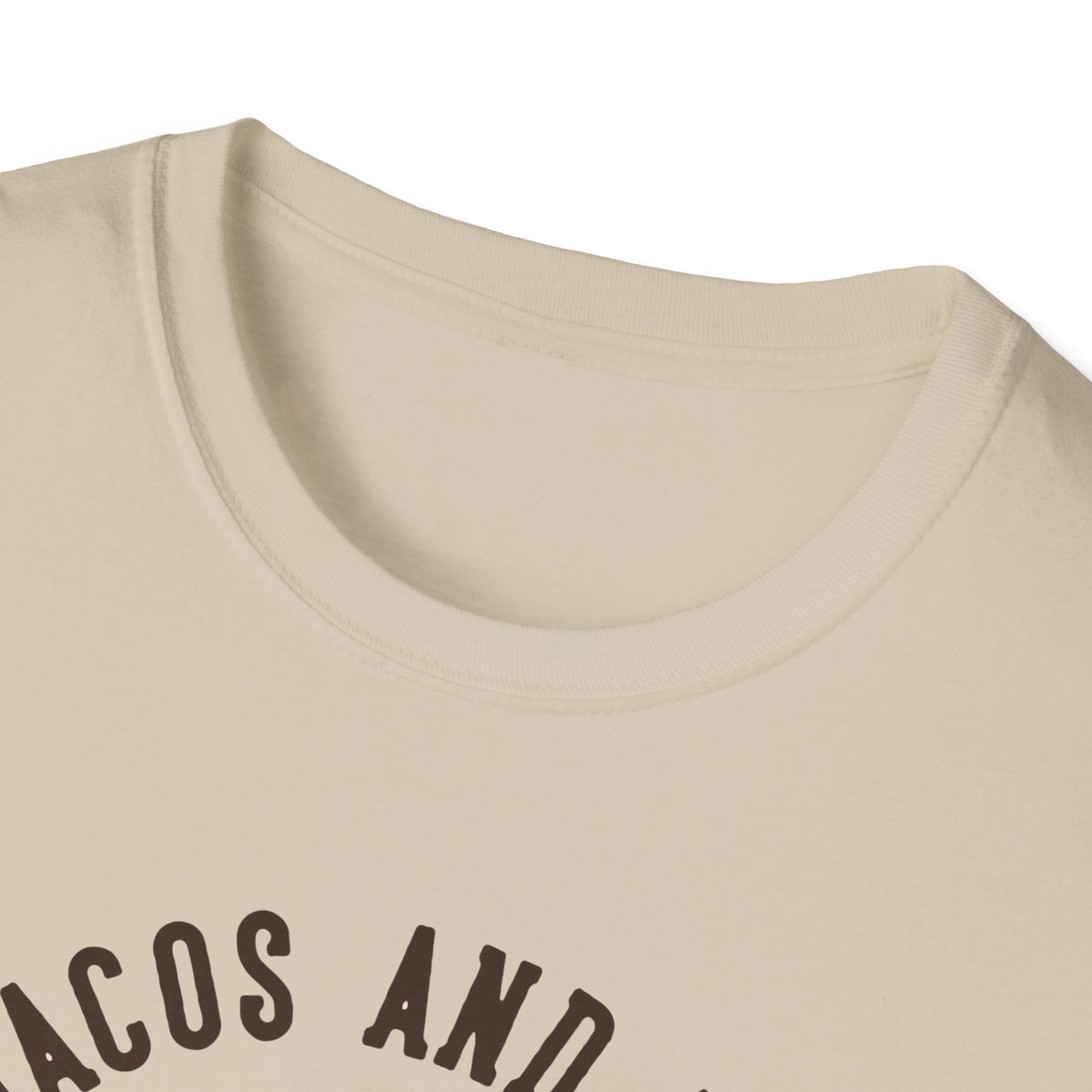 Close-up of 'Feed Me Tacos and Tell Me I'm Pretty' t-shirt text in sand, funny taco graphic tee