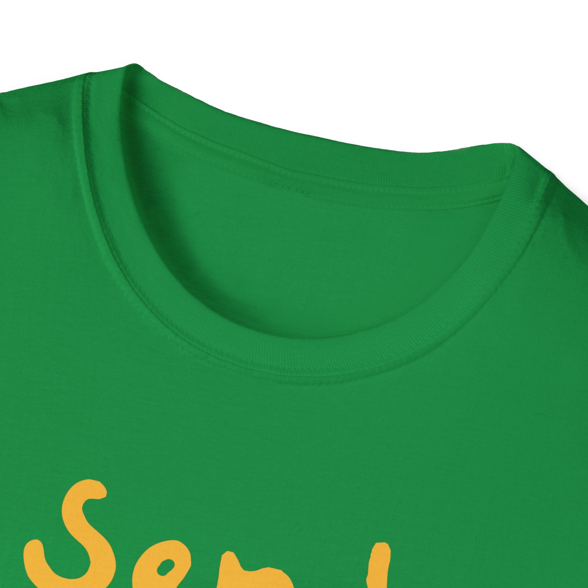 The "Send Noods" T-Shirt features a close-up of a green fabric with partially visible yellow text, highlighting its quirky humor with a playful phrase. The stylish fit ensures that this T-shirt is both trendy and fun.