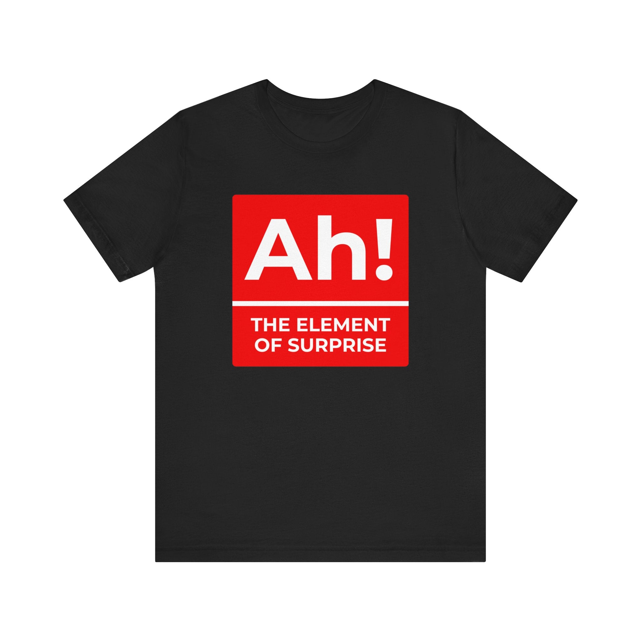 The "Ah! the Element of Surprise" T-shirt is a black comfy tee featuring a red periodic table-style box with "Ah!" and the phrase in white, perfect for science and nerd culture fans.