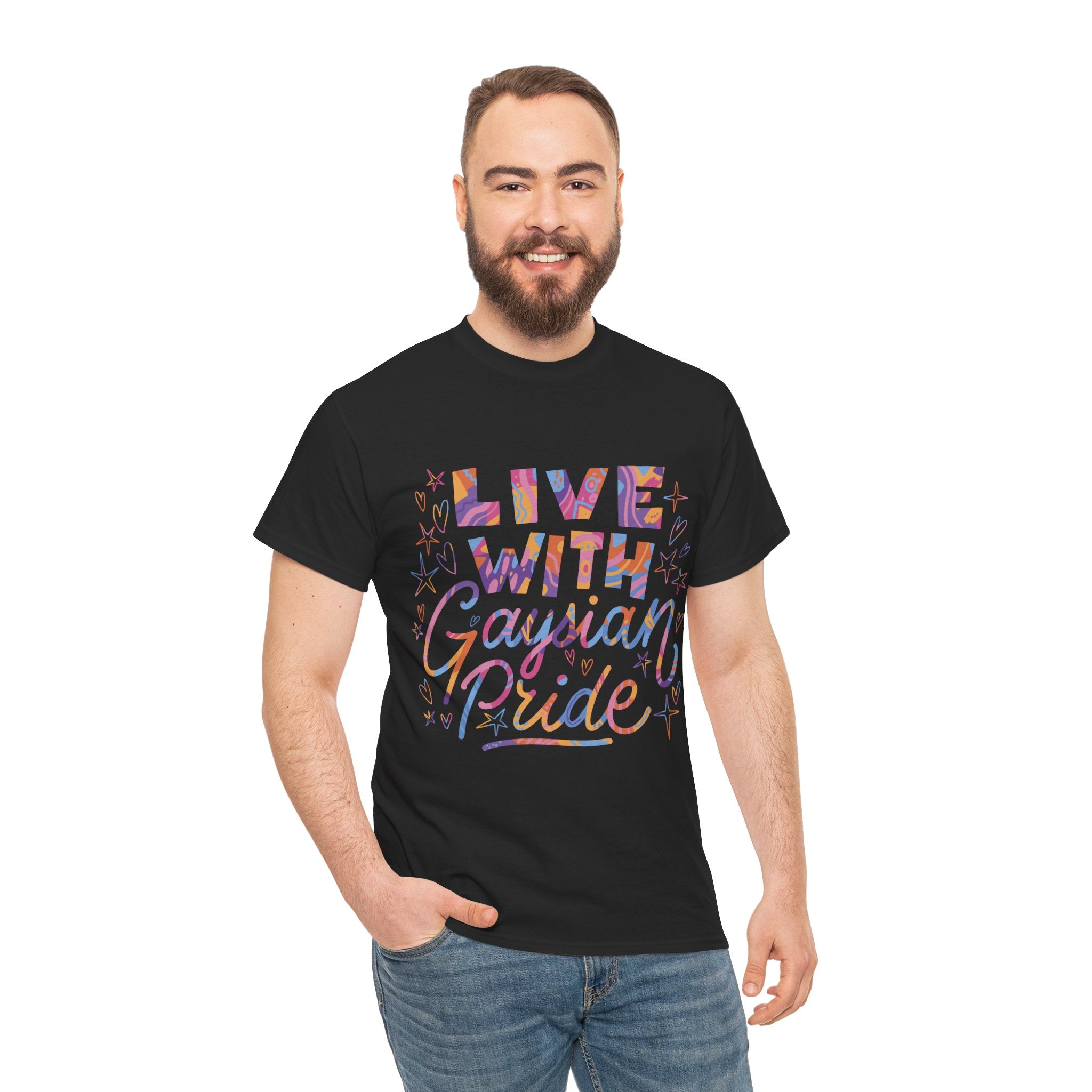 A man in jeans and a black "Live With Gaydian Pride" t-shirt, featuring multicolored text, stands against a plain white background. This tee is perfect for those celebrating nerd culture with pride and style.