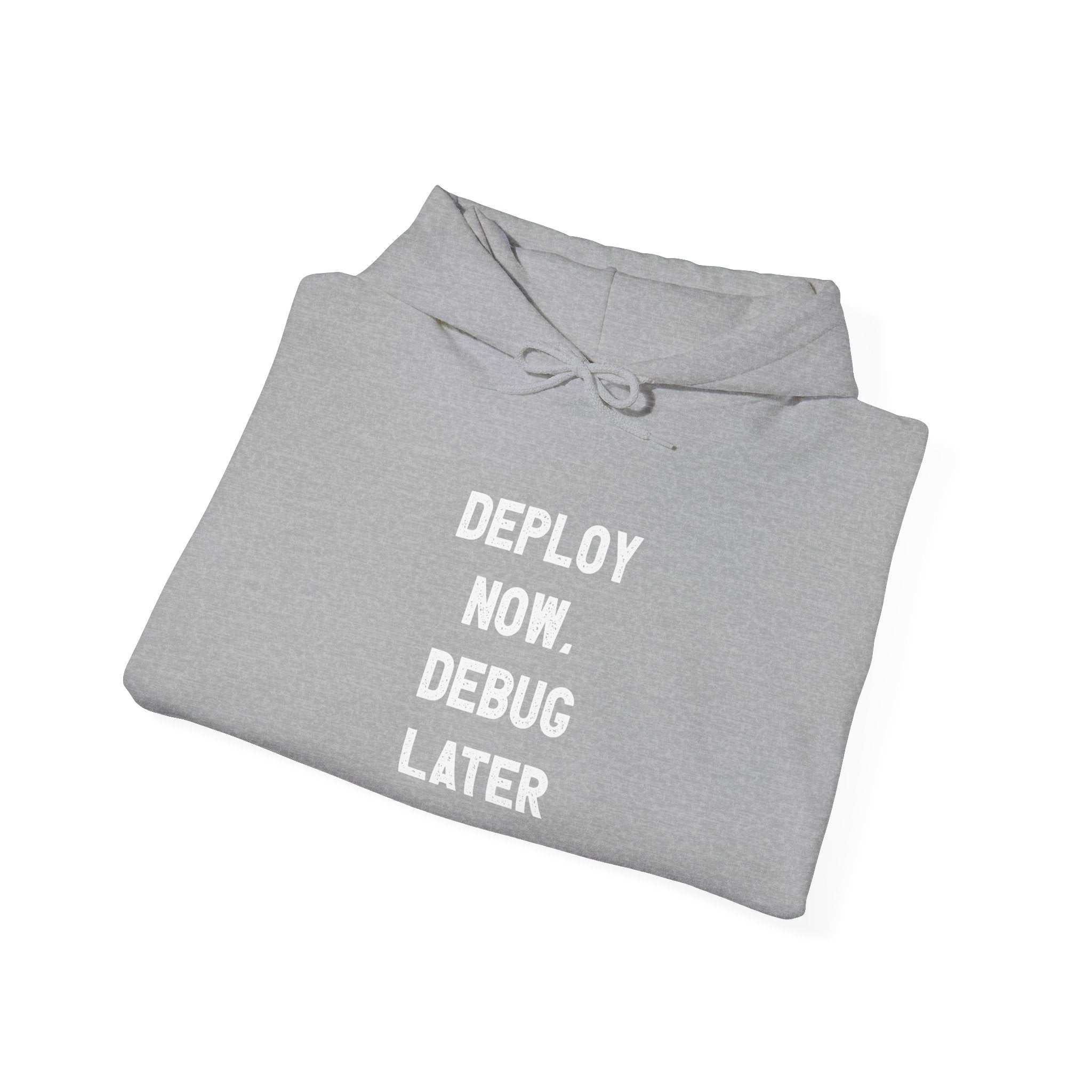 The "Deploy Now, Debug Later - Hooded Sweatshirt" seamlessly merges comfort with style, showcasing bold white text on a gray Heavy Blend hoodie. It strikes an ideal balance of casual wear infused with humor, making it a perfect addition to any coder's wardrobe.