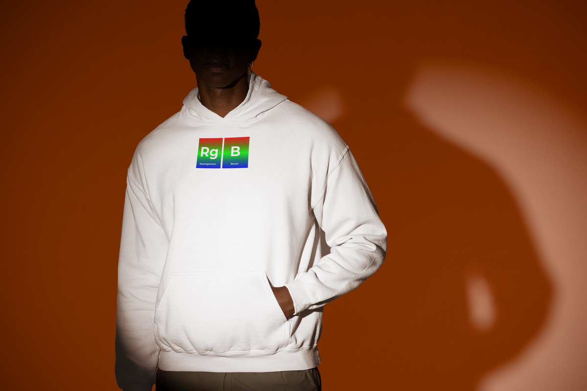 'RG-B Periodic Table Hoodie' in white, man under a spotlight, Hoodie mockup, Geekpsters