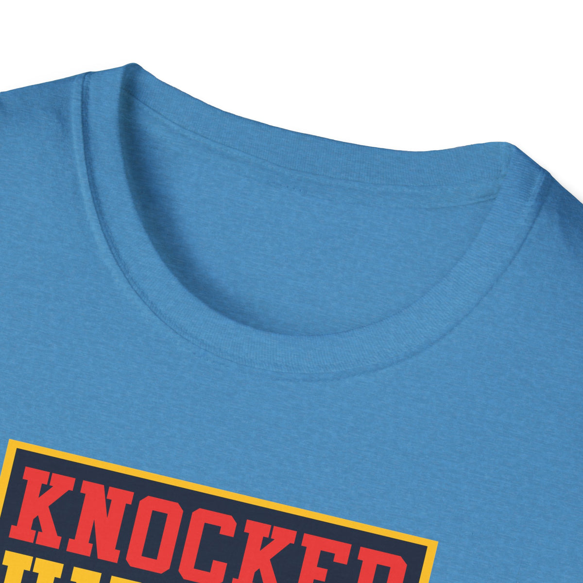 Close-up of "Knocked Him Out" robot boxing print on denim blue t-shirt collar, retro arcade detail