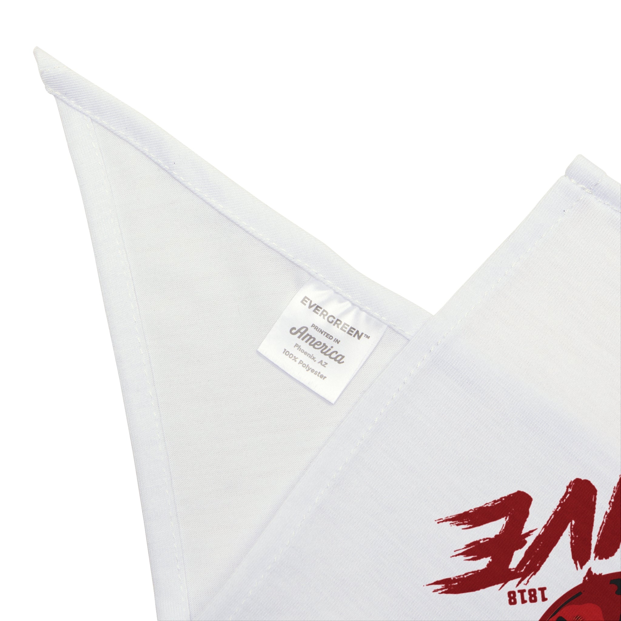 A close-up of the Alive- Pet Bandana shows its white fabric with a sewn label reading "EVERGREEN® America 100% polyester" and part of a red printed design visible on the right.
