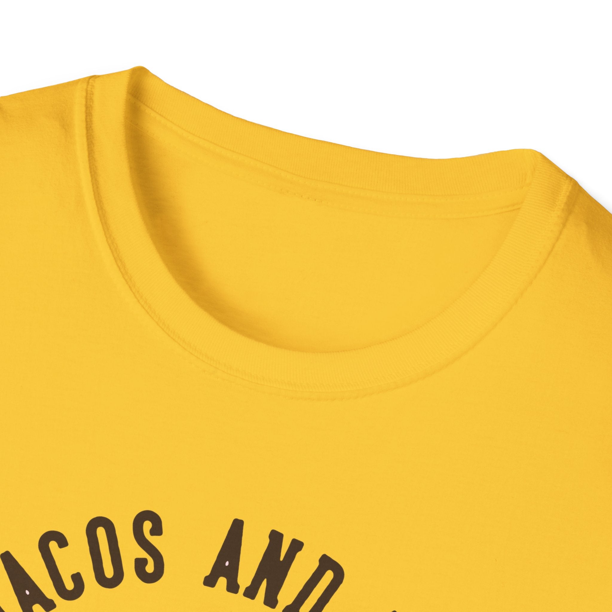 Close-up of the neckline of a yellow "Feed Me Tacos and Tell Me I'm Pretty" T-shirt, perfect for taco lovers, with black text partially visible.