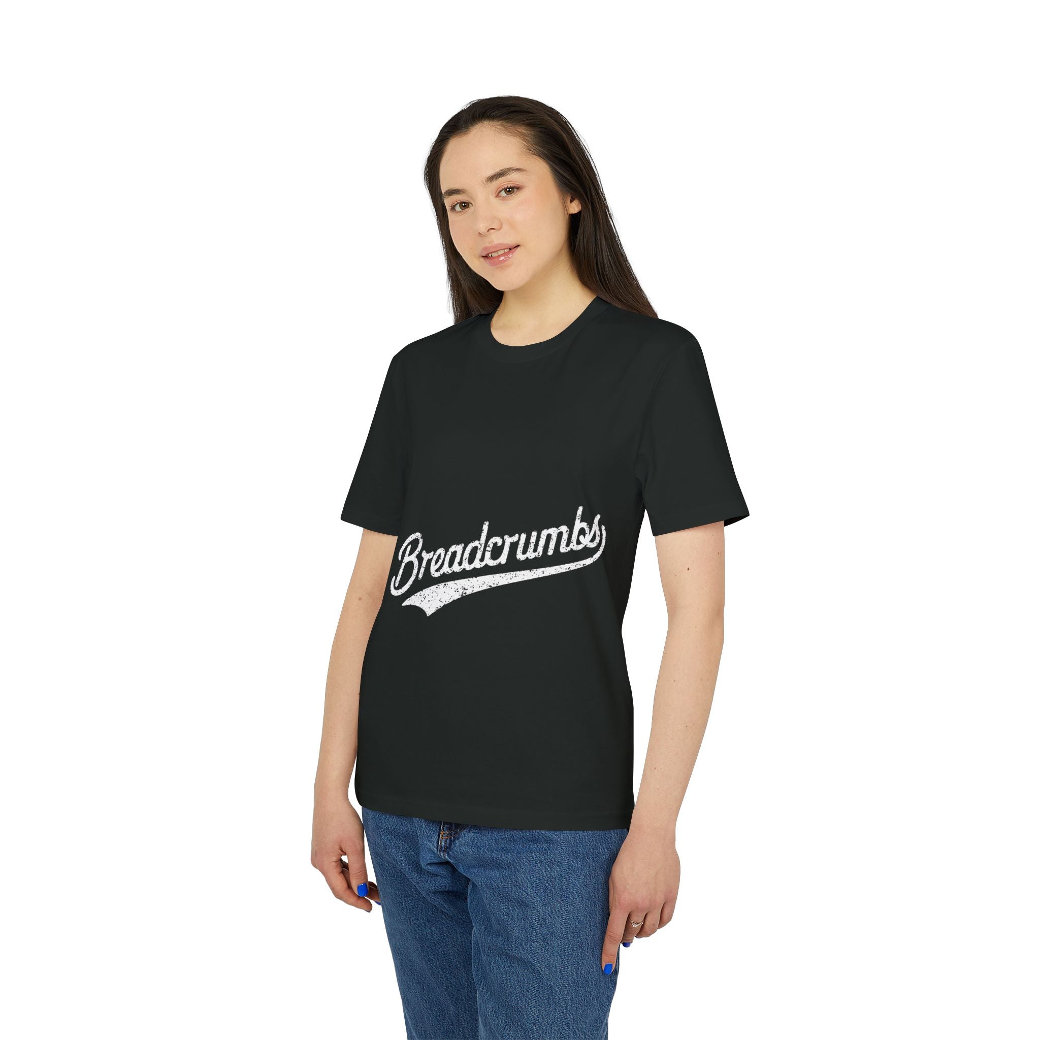A person wears the Breadcrumbs - Organic T-Shirt, black and made of organic cotton, featuring "Breadcrumbs" in white script—a perfect programmer's shirt from the Organic Sci-Fi Tee collection.