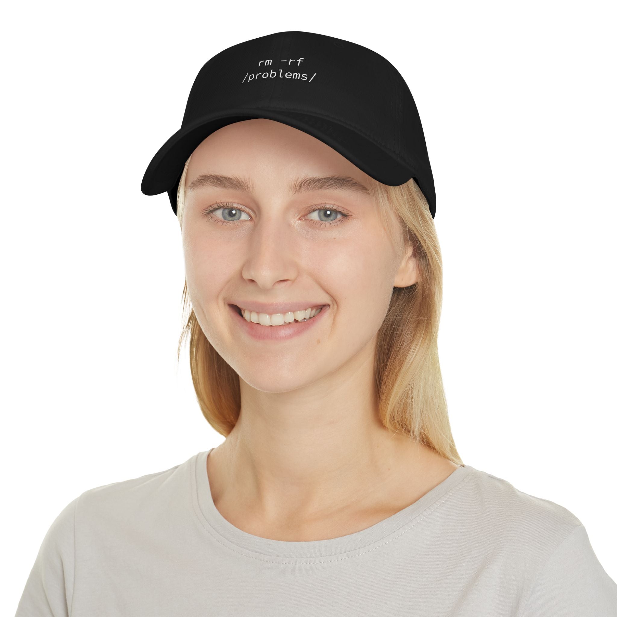 A person wearing an "RMRF Problems" hat in black, featuring reinforced stitching, along with a light-colored shirt, is smiling at the camera.