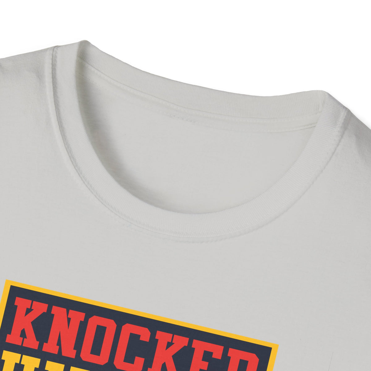 Close-up of "Knocked Him Out" robot boxing print on light grey t-shirt collar, retro arcade detail