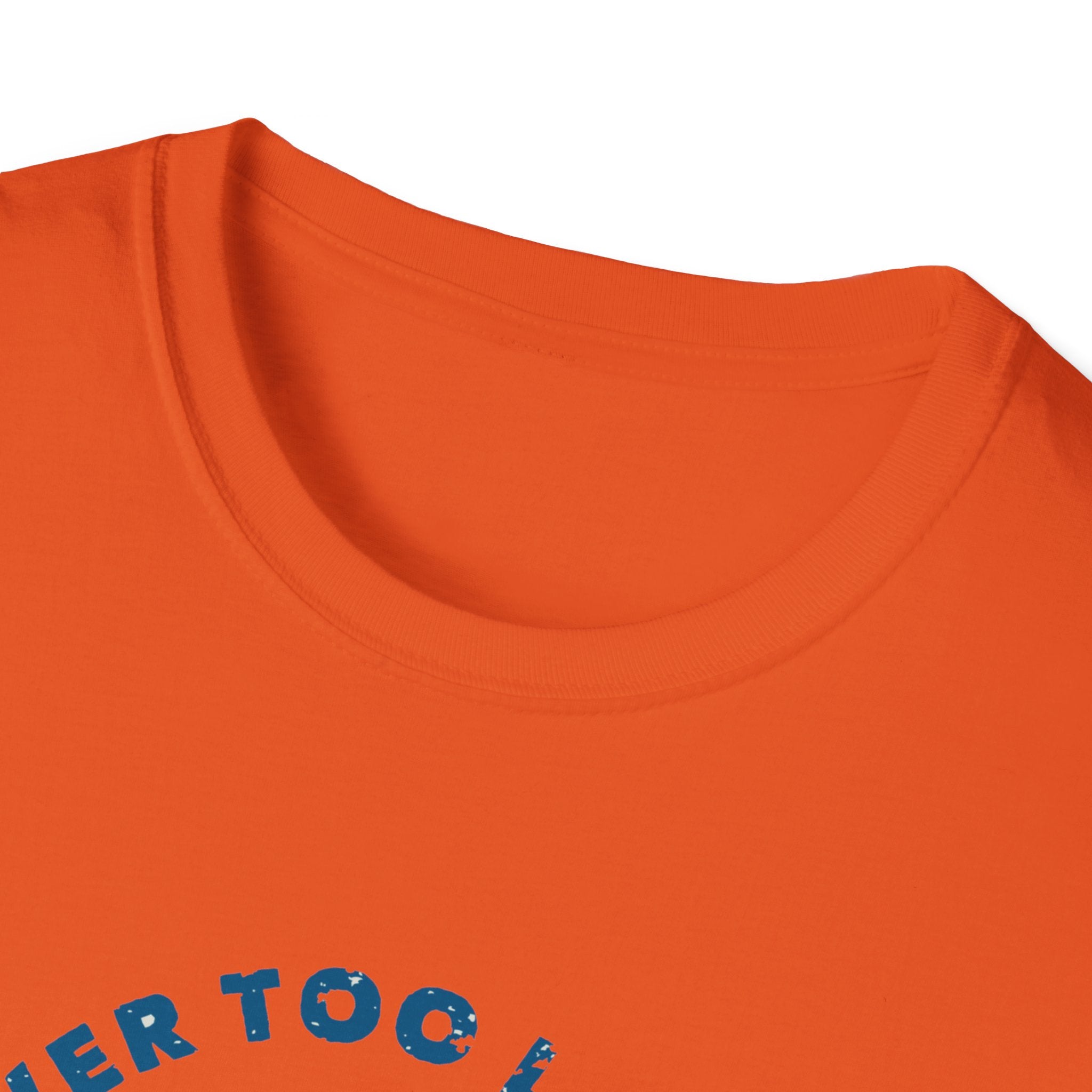 Close-up of an orange "Never Too Late to Skate" tee shirt featuring partially visible blue printed text that inspires a passion for skating.