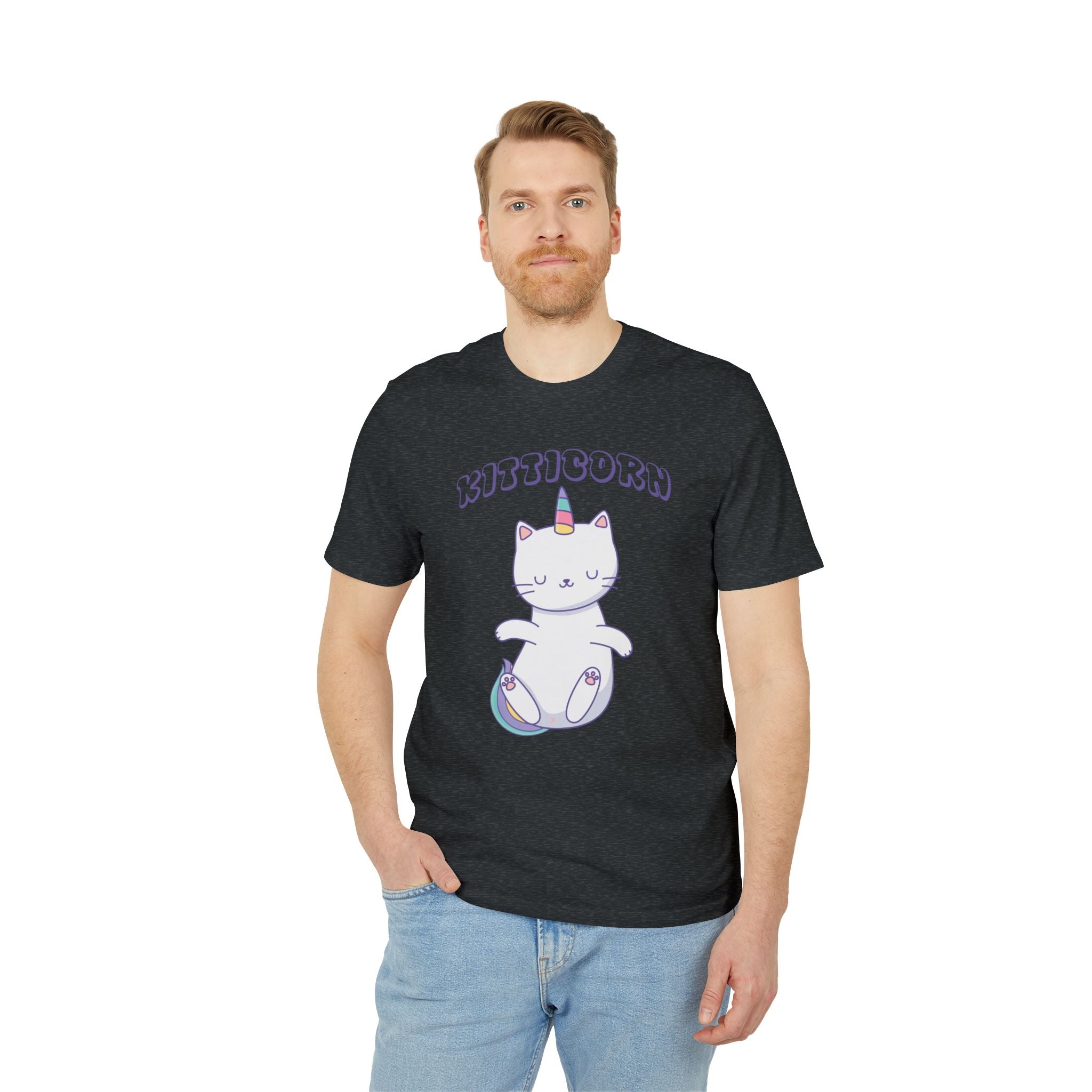 A man poses with one hand in his jeans pocket, wearing the Organic T-Shirt - Kitticorn Design featuring a cat with a unicorn horn and "Kitticorn" above—an adorable, unique gift for animal lovers.