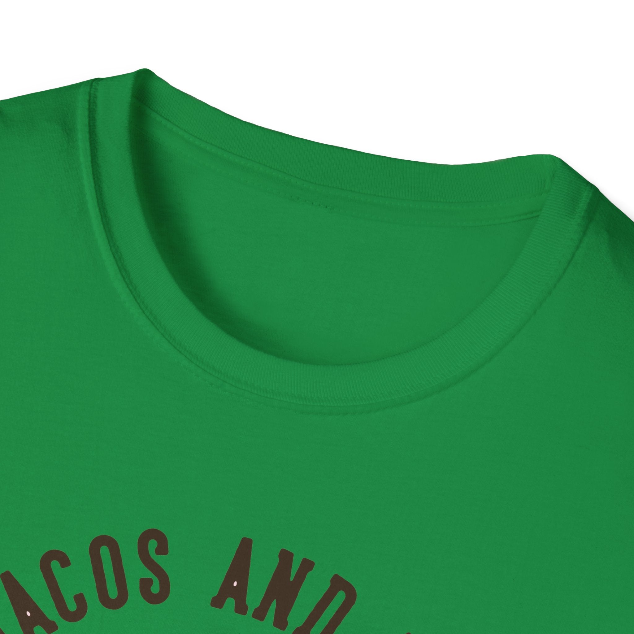 Close-up of a green T-shirt with the partially visible text "Feed Me Tacos and Tell Me I'm Pretty" in brown letters, ideal for taco enthusiasts.