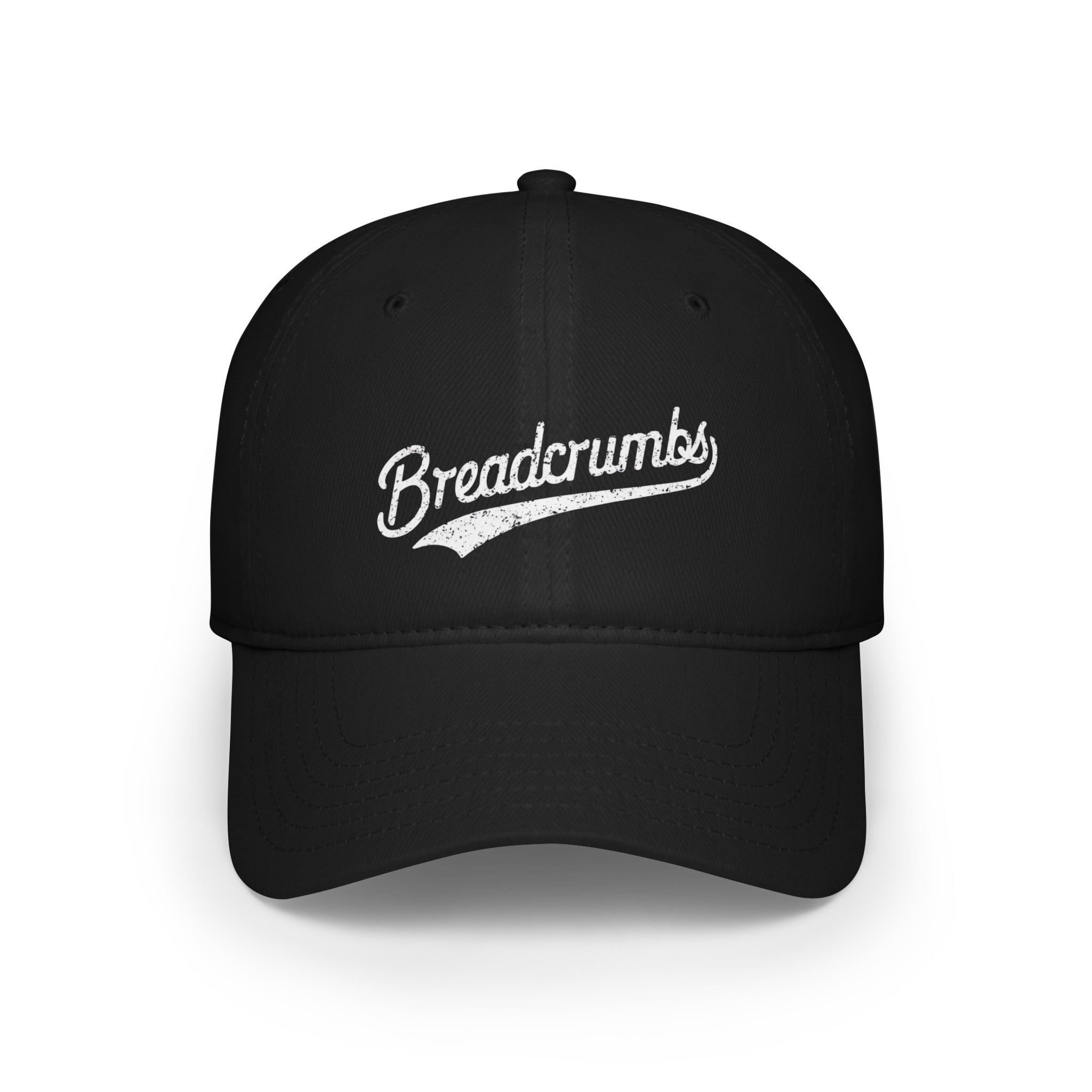 A black "Breadcrumbs - Hat" with the word "Breadcrumbs" written in white script on the front, featuring smooth fabric and reinforced stitching for added durability.