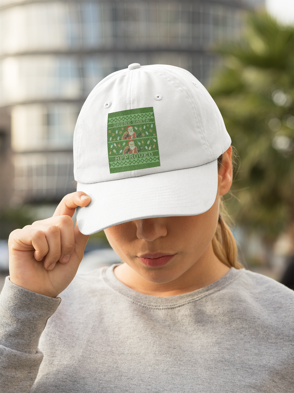 'Drunk Santa Approved' Santa graphic dad hat in white, woman wearing it outdoors, funny Christmas cap gift for her