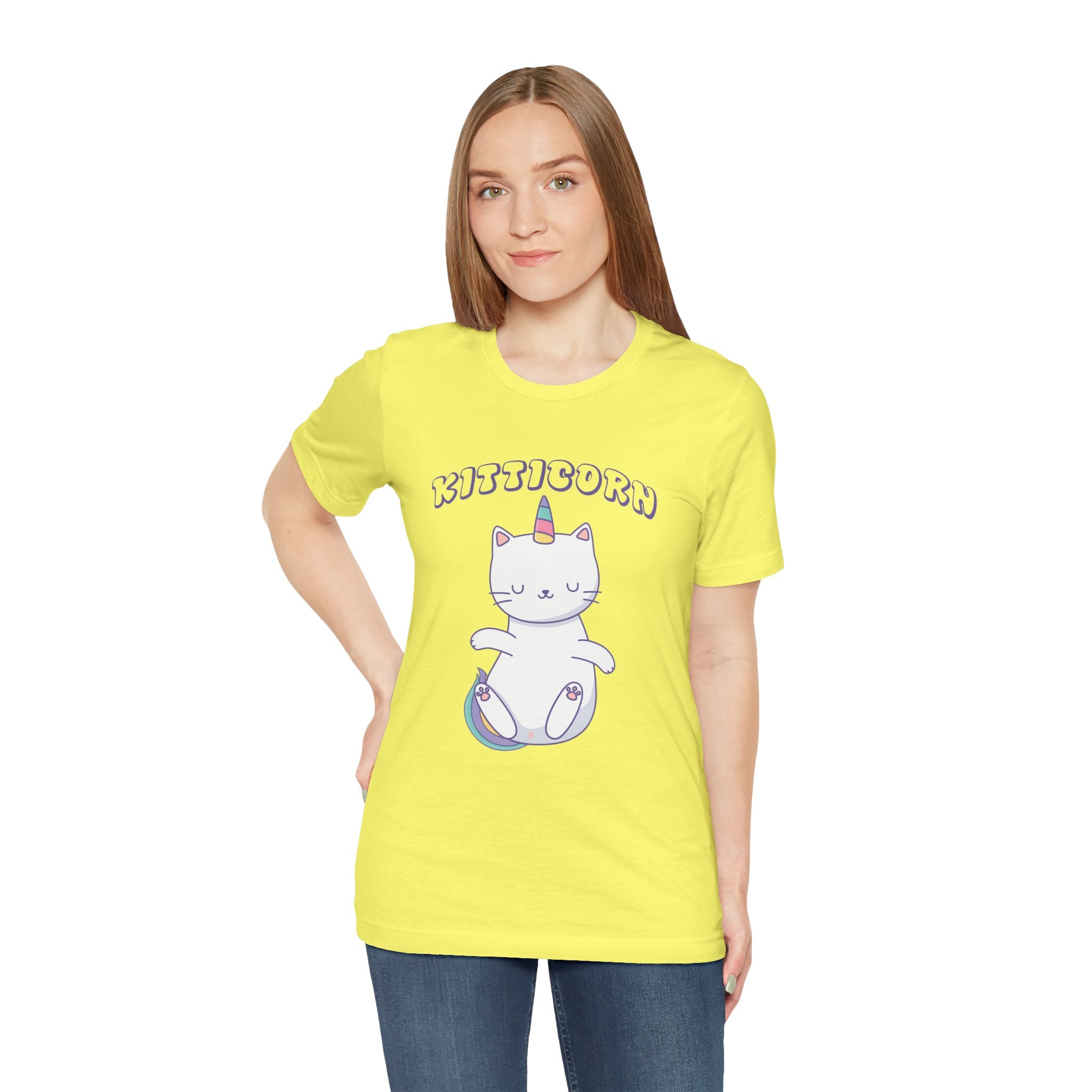 A woman wears a yellow Kitticorn tee, showcasing a cartoon cat-unicorn with "Kitticorn" on the front—ideal for unicorn and pop culture fans.