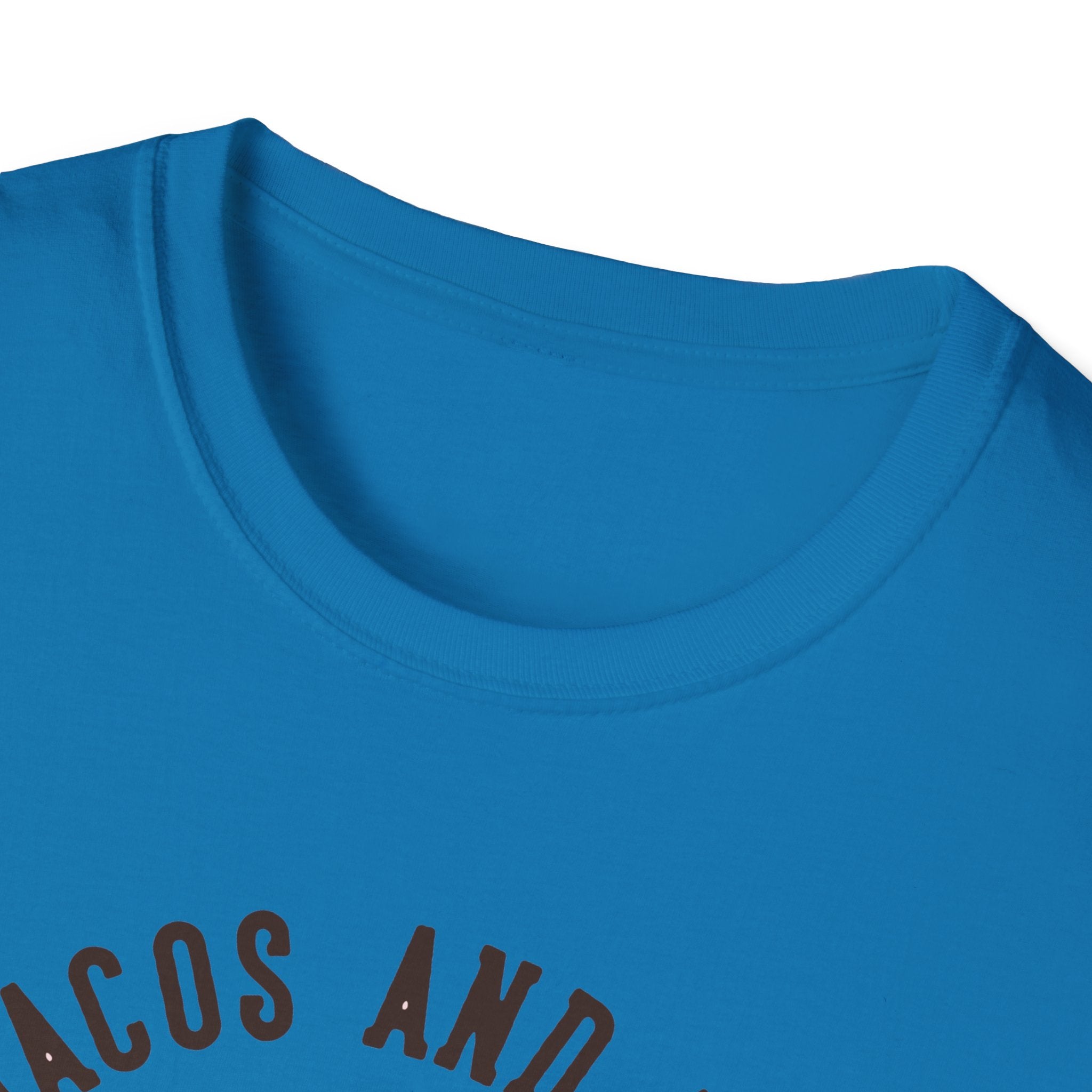 Close-up of a blue T-shirt with partial black lettering that reads "Feed Me Tacos and Tell Me I'm Pretty," perfect for taco lovers and ideal for celebrating Taco Tuesdays.