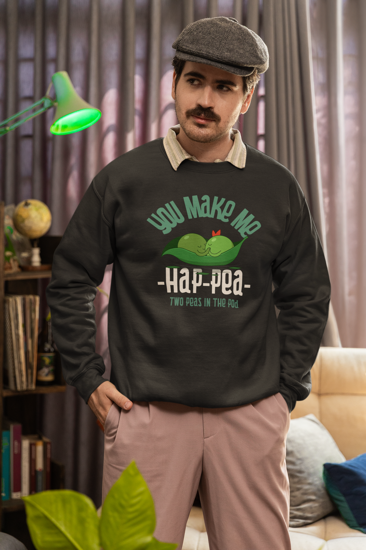 'You Make Me Ha-Pea' pea pun sweatshirt in black, man wearing it indoors, funny vegetable pun gift