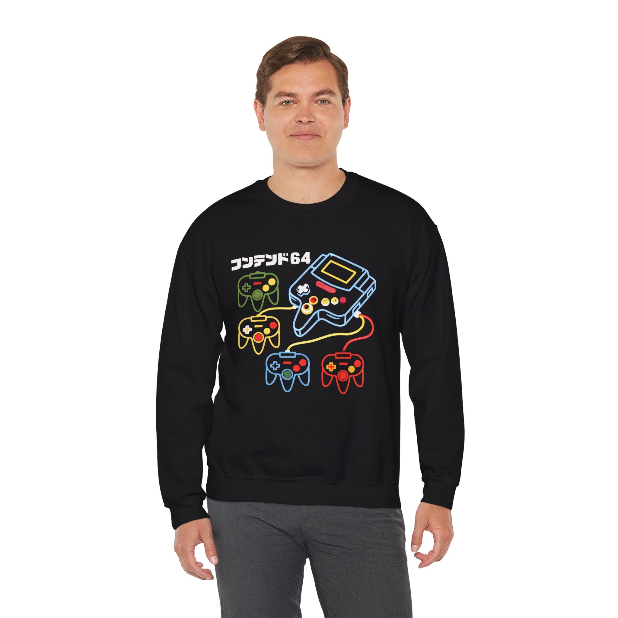 A man wearing the Game Console - Sweatshirt with colorful Nintendo 64 controllers, console graphics, and Japanese text on the chest stands against a white background—ideal for coding marathons or adding a sci-fi twist to your style.
