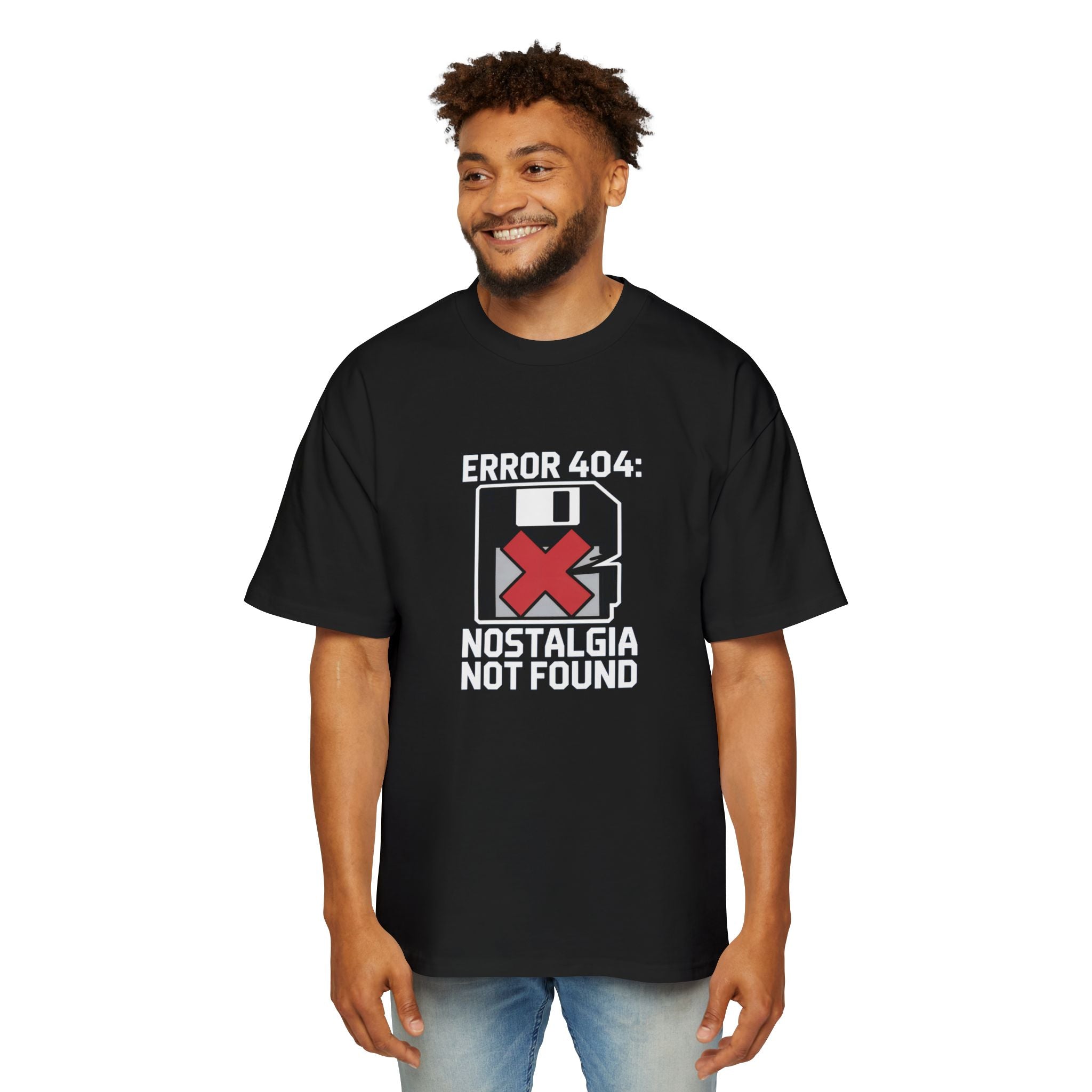A man wears the Error 404 Nostalgia Not Found - Heavy Oversized Tee, featuring "ERROR 404: NOSTALGIA NOT FOUND" text, a floppy disk graphic, and a red X.
