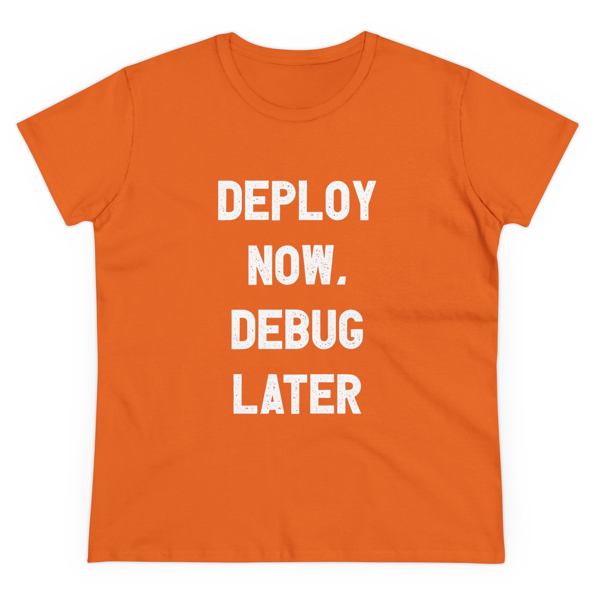 The "Deploy Now, Debug Later - Women's Tee" showcases bold white text on an orange background, crafted from high-quality cotton.