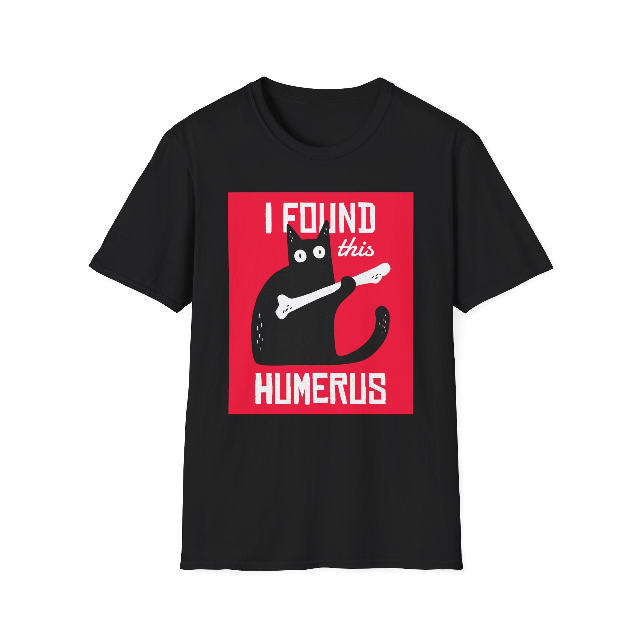 The "I Found This Humerus T-Shirt" offers a unique spin on traditional clothing with a black tee showcasing a cartoon cat holding a bone and the phrase "I FOUND this HUMERUS" against a vivid red backdrop. It's perfect for anyone who appreciates witty humor in their fashion choices.