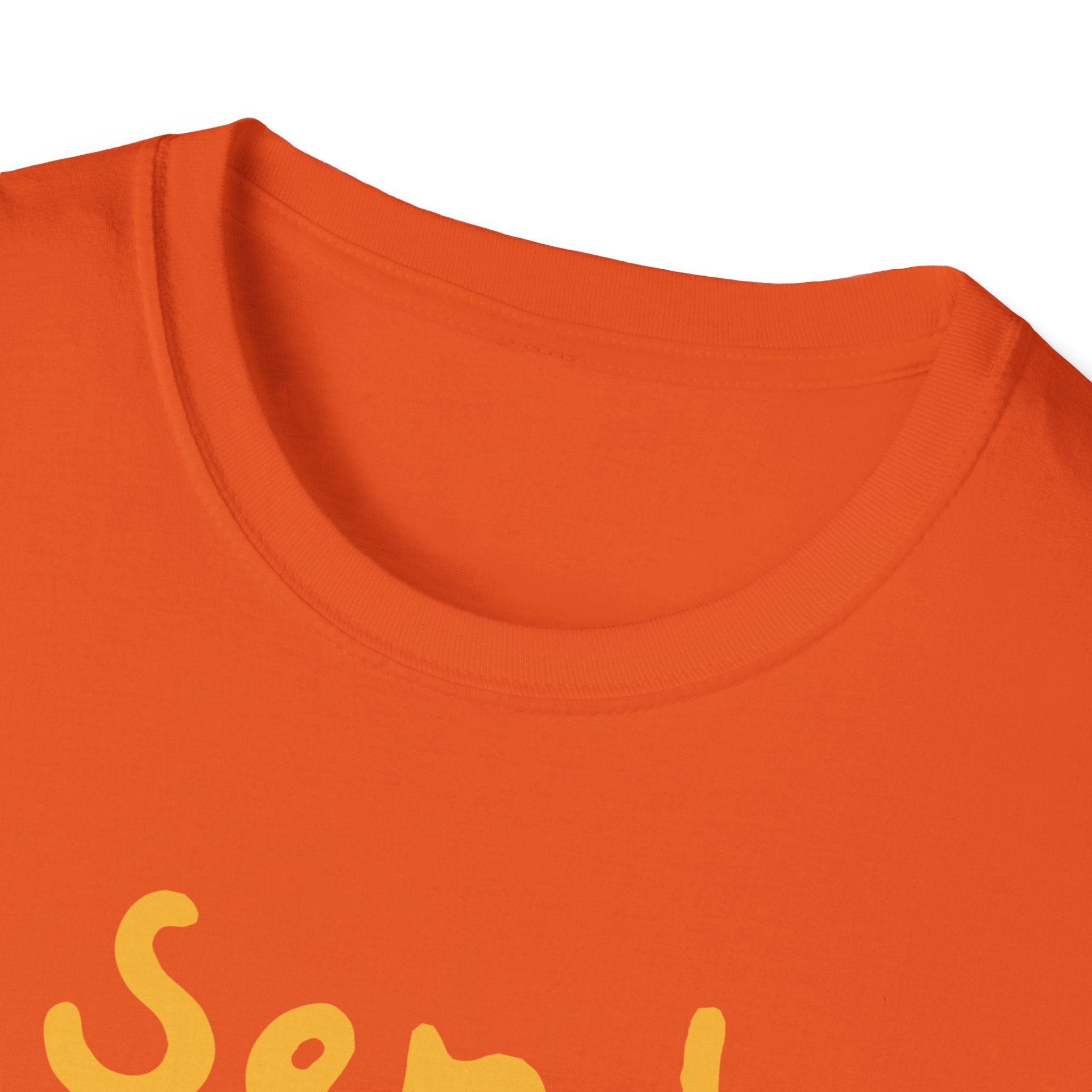 A close-up shot displays a stylish orange T-shirt with a humorous phrase in partially visible yellow text. The "Send Noods T-Shirt" is laid flat, highlighting the neckline and a section of the front design.