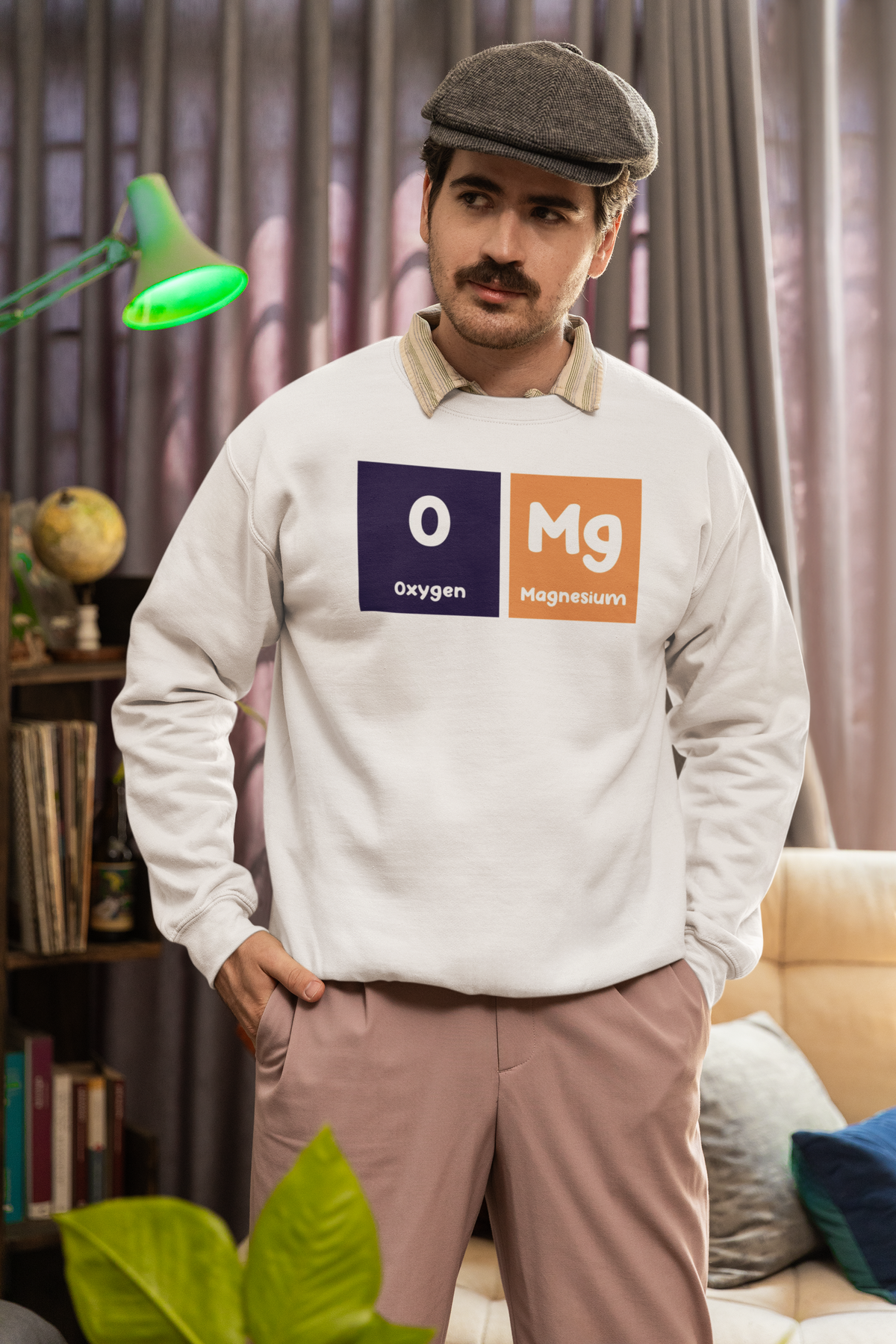 'O-Mg' periodic table sweatshirt in heather oatmeal, man wearing it at home, funny science pun gift