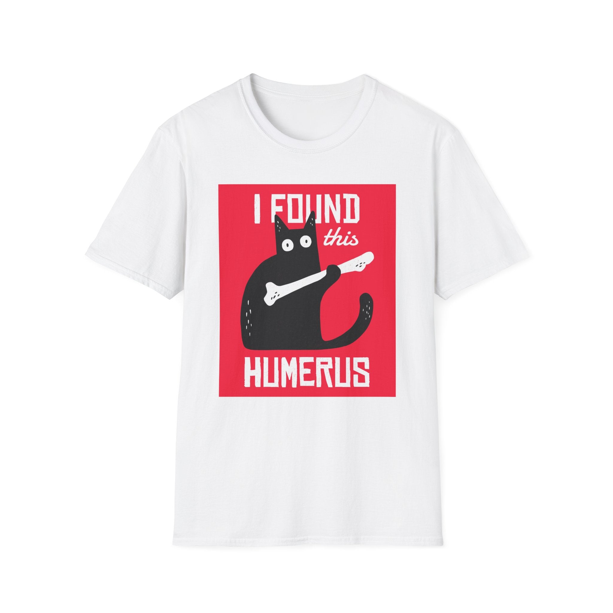 Inject some humor into your wardrobe with the "I Found This Humerus" T-shirt, a white shirt showcasing a cartoon black cat holding a bone against a lively red backdrop.