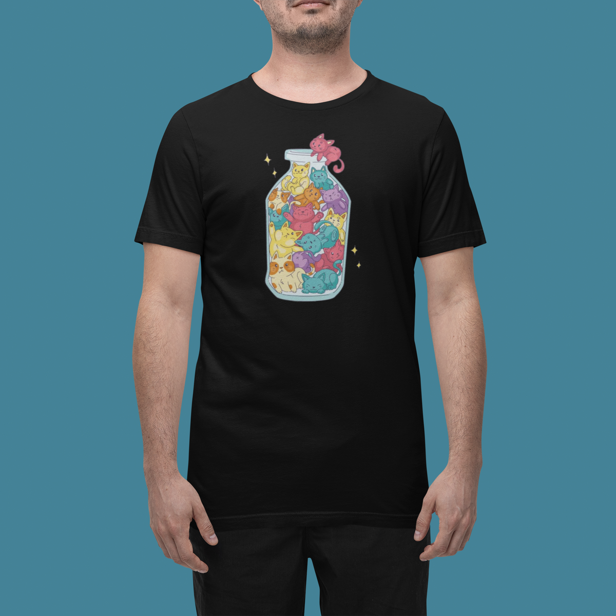 'Cats in a Bottle' t-shirt in black, man wearing it in a studio, T-Shirt mockup, Geekpsters