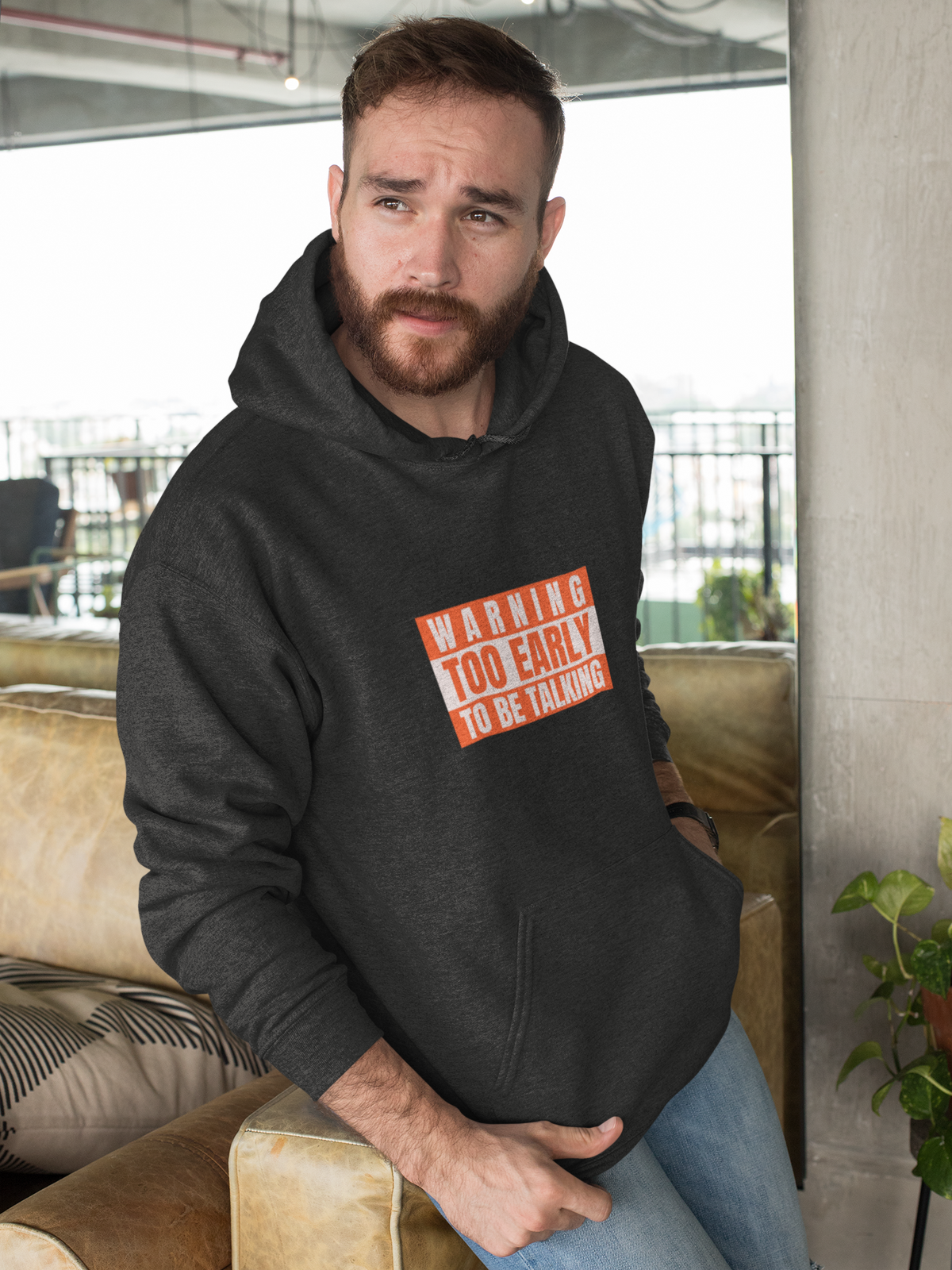 'Warning Too Early To Be Talking' funny morning hoodie in charcoal, bearded man sitting indoors, gift