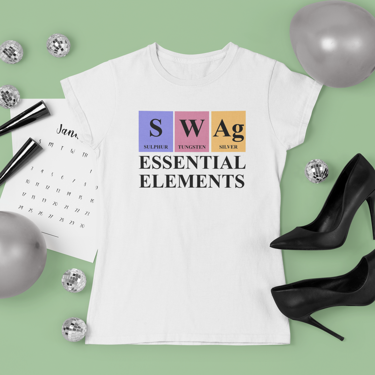 'SWAg, Essential Elements' periodic table t-shirt in white, flat lay styled with heels and confetti, funny gift
