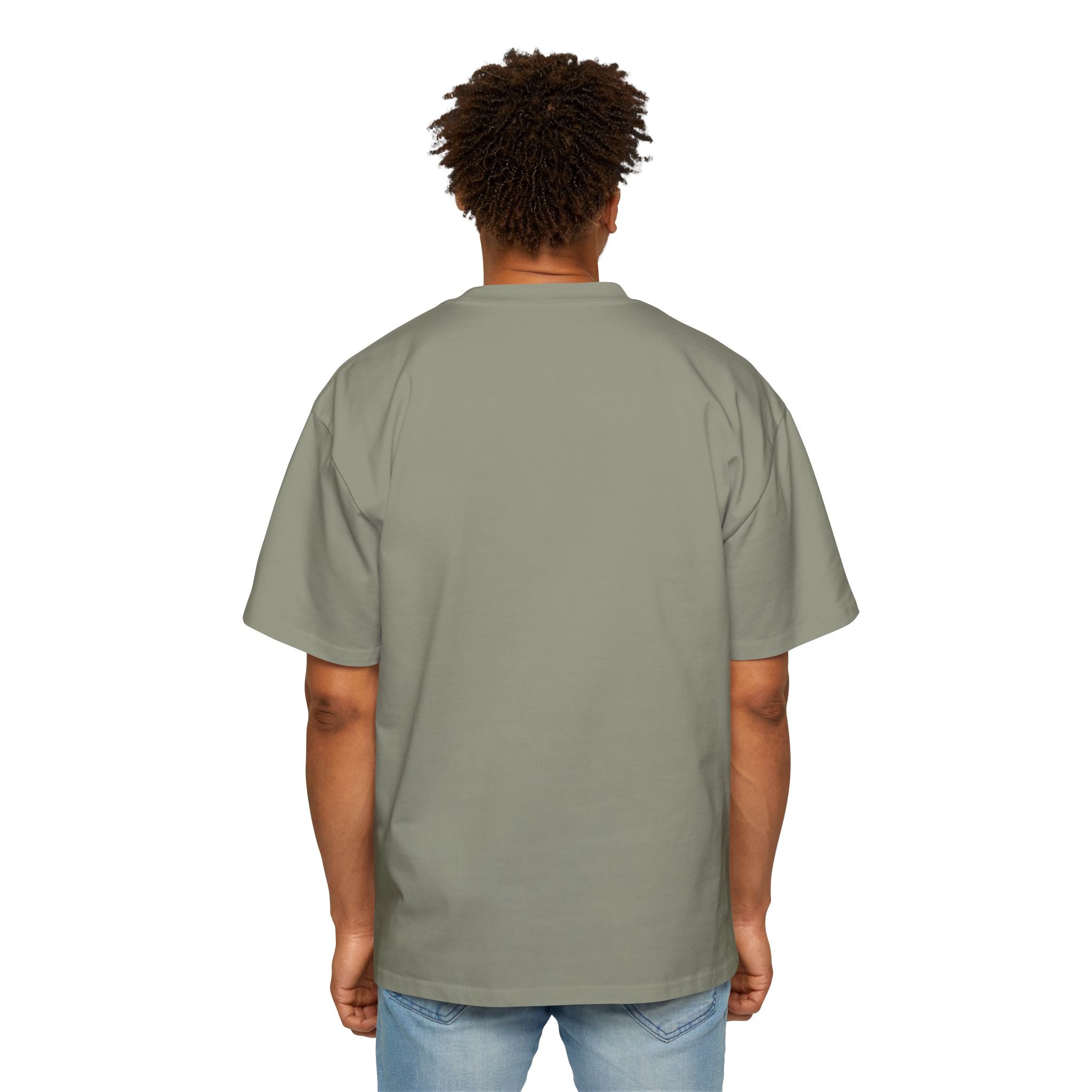 A person with short curly hair is seen from the back wearing the Blockchain developer - Heavy Oversized Tee and light blue jeans, standing against a plain white background.